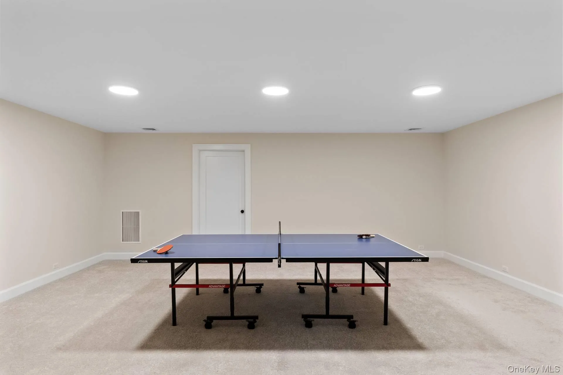 Recreation room with light carpet and recessed lighting Recreation room with light carpet and recessed lighting