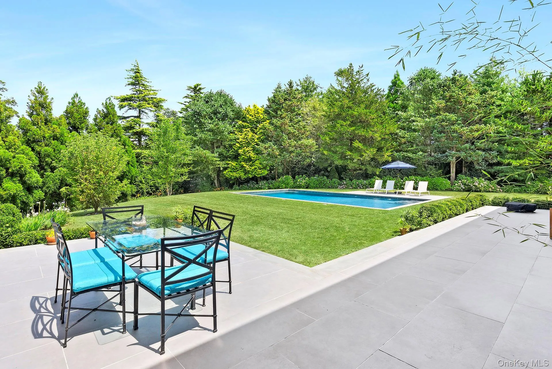 Outdoor pool with a patio, a yard, and outdoor dining area Outdoor pool with a patio, a yard, and outdoor dining area