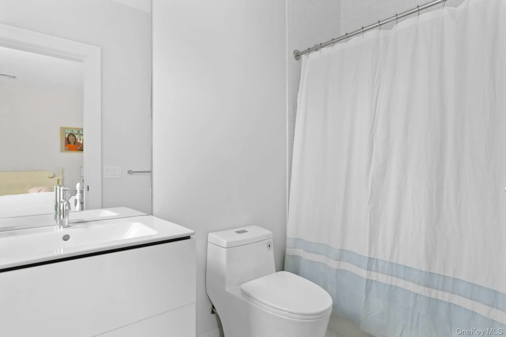 Bathroom with vanity and curtained shower Bathroom with vanity and curtained shower
