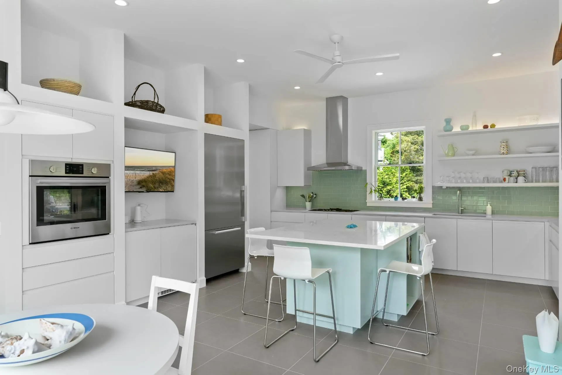 Kitchen featuring open shelves, white cabinetry, modern cabinets, stainless steel appliances, and light tile patterned flooring Kitchen featuring open shelves, white cabinetry, modern cabinets, stainless steel appliances, and light tile patterned flooring