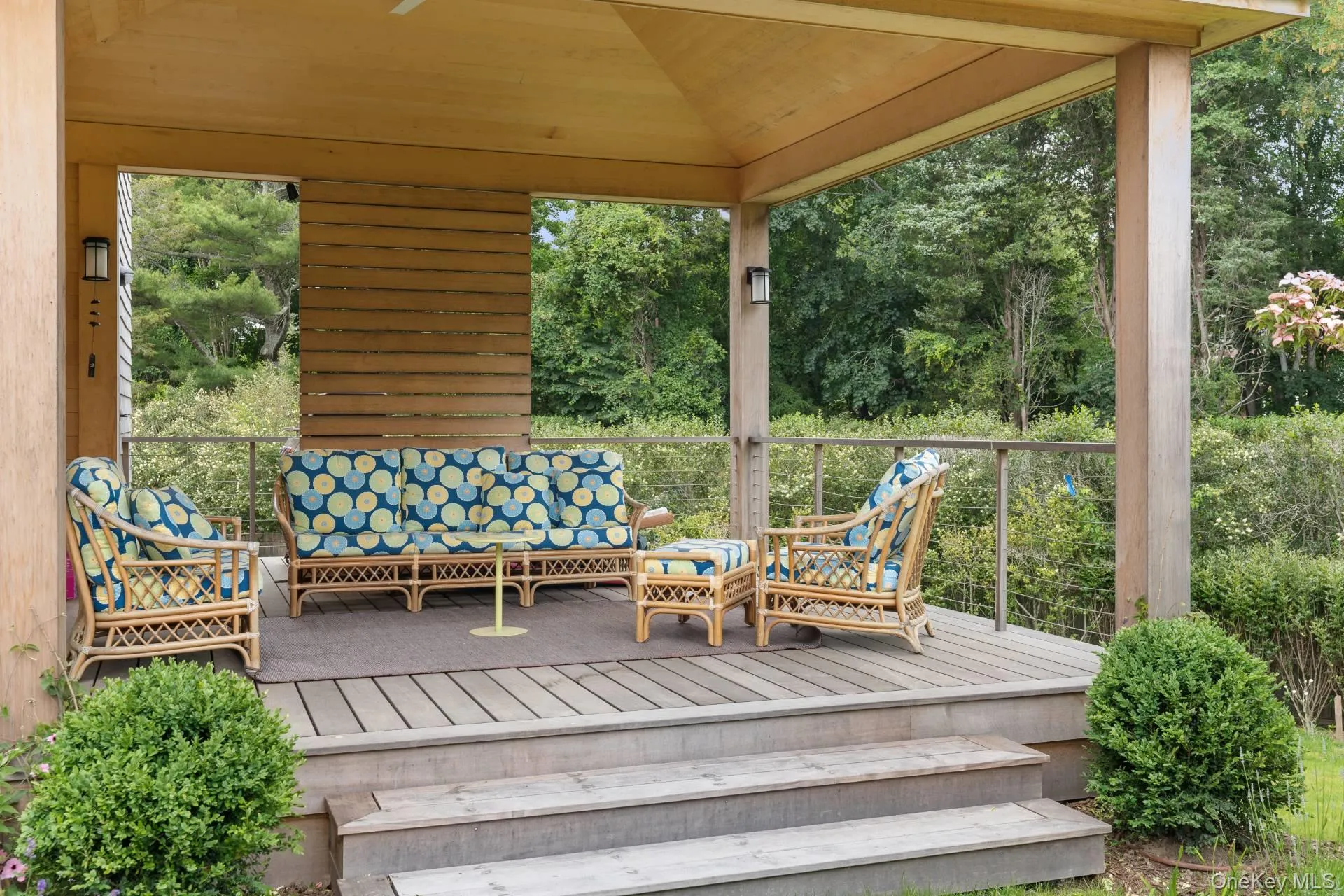 Wooden deck featuring view of scattered trees and an outdoor living space Wooden deck featuring view of scattered trees and an outdoor living space