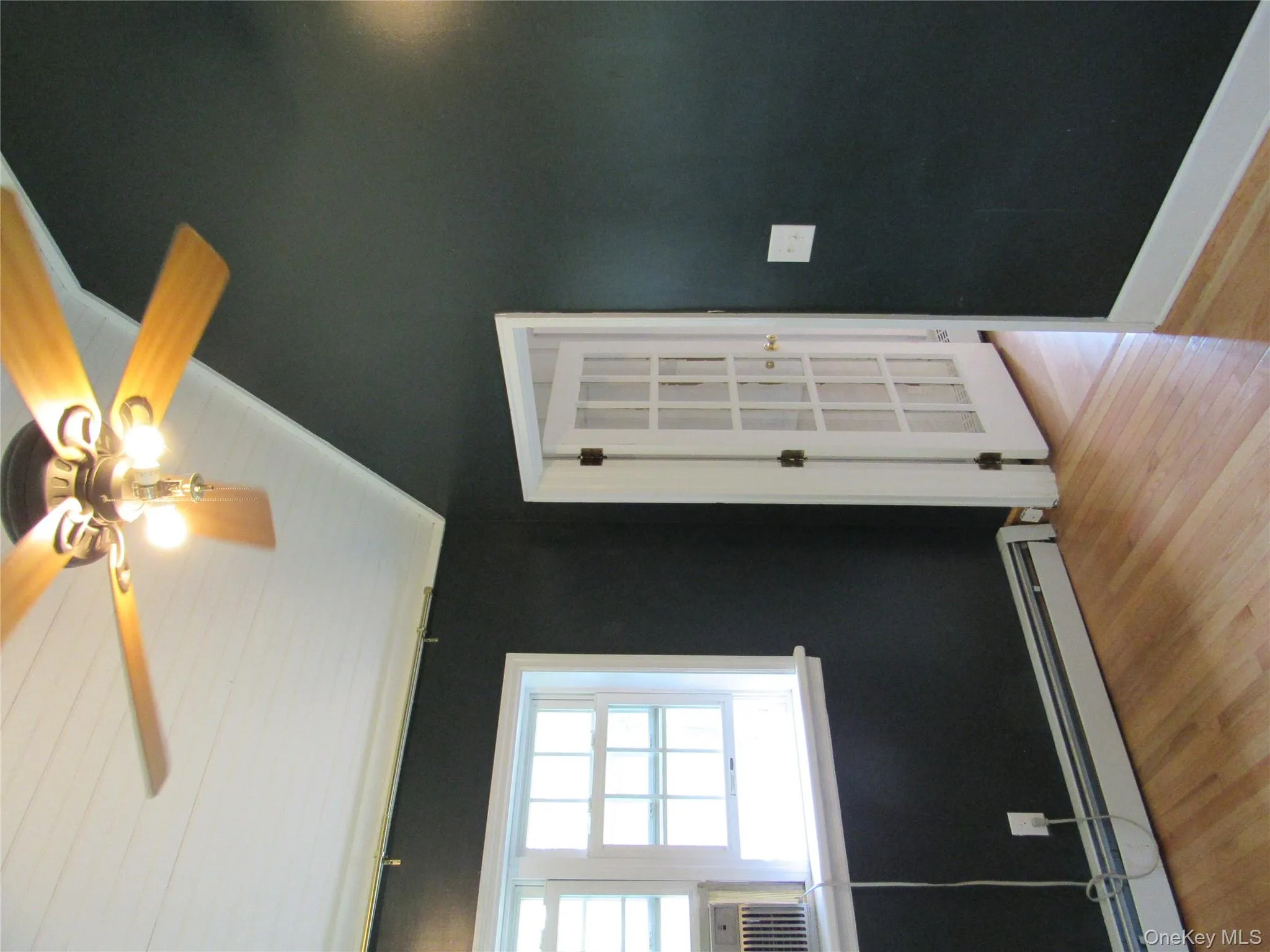 Office/Den room with vaulted ceiling, a ceiling fan, a baseboard radiator, and light wood-style floors Office/Den room with vaulted ceiling, a ceiling fan, a baseboard radiator, and light wood-style floors