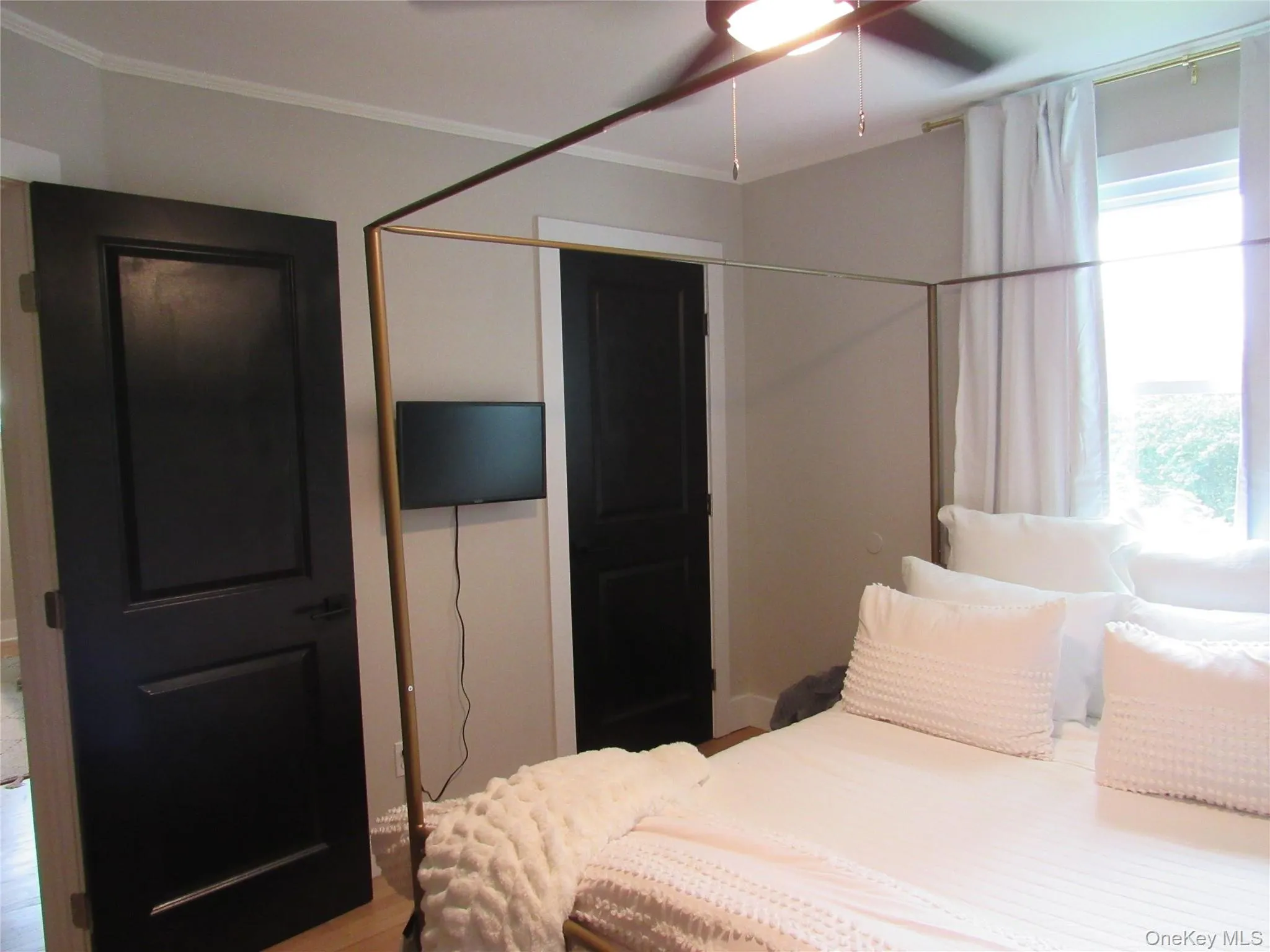 Bedroom# 1 with light wood-type flooring, a ceiling fan, and crown molding Bedroom# 1 with light wood-type flooring, a ceiling fan, and crown molding