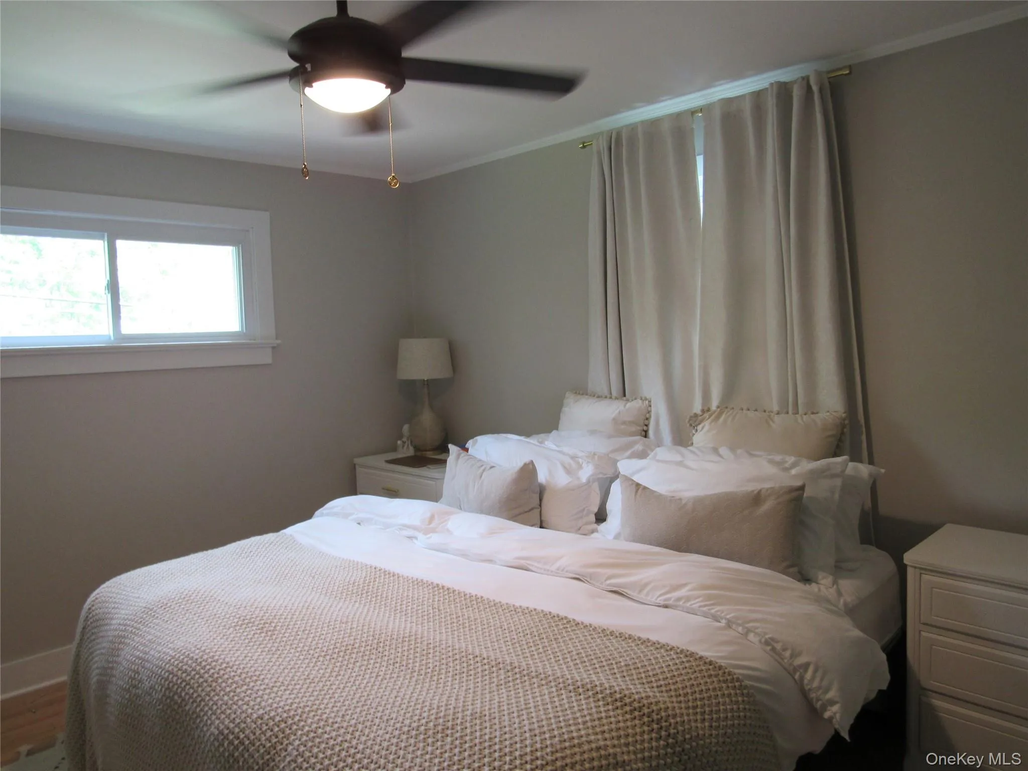 Bedroom #2 with a ceiling fan and ornamental molding Bedroom #2 with a ceiling fan and ornamental molding