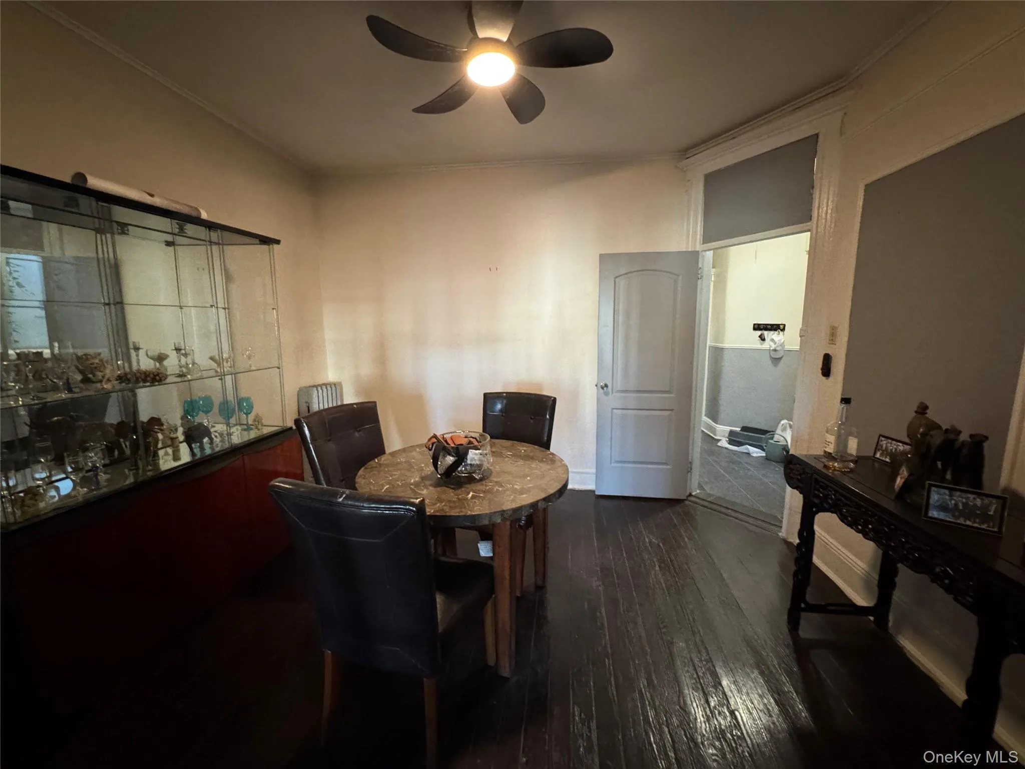 Dining room with dark wood-style floors and a ceiling fan Dining room with dark wood-style floors and a ceiling fan
