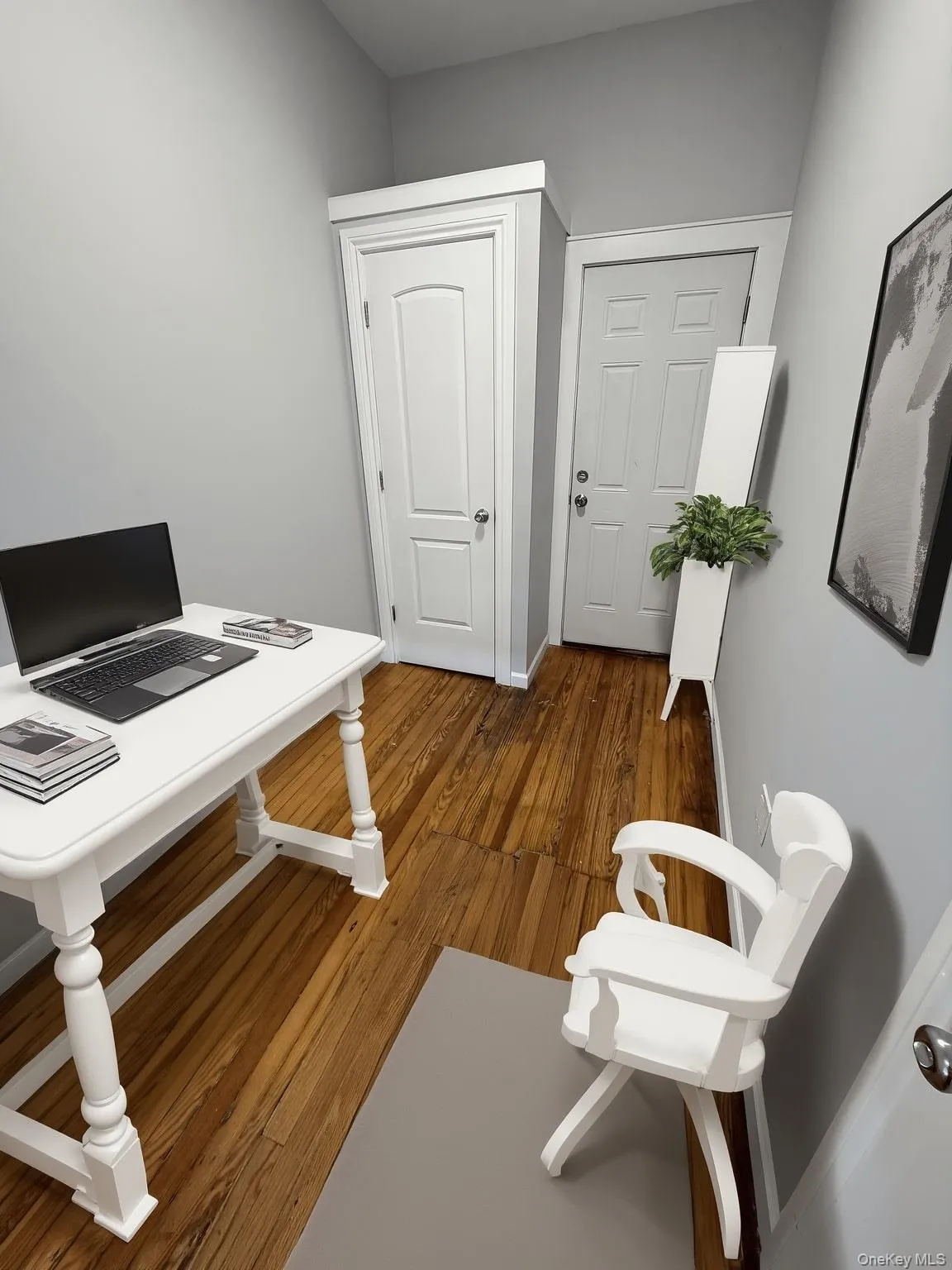 Home office featuring dark wood-type flooring Home office featuring dark wood-type flooring