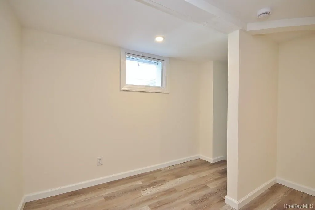 Below grade area with light wood-style flooring and recessed lighting Below grade area with light wood-style flooring and recessed lighting