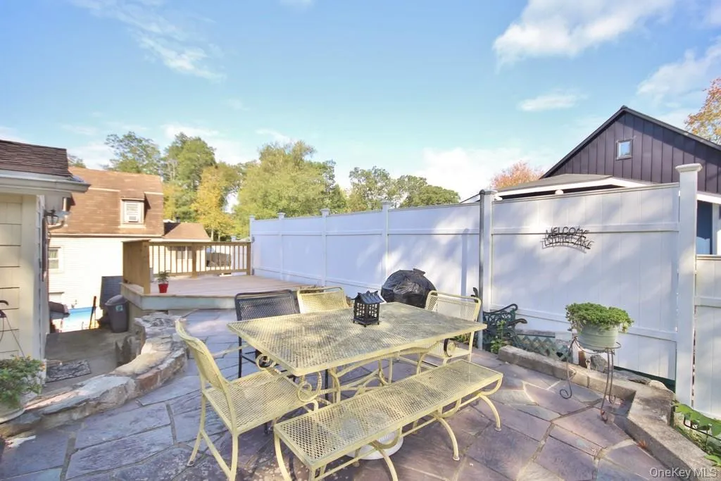 View of patio / terrace featuring outdoor dining area and a deck View of patio / terrace featuring outdoor dining area and a deck