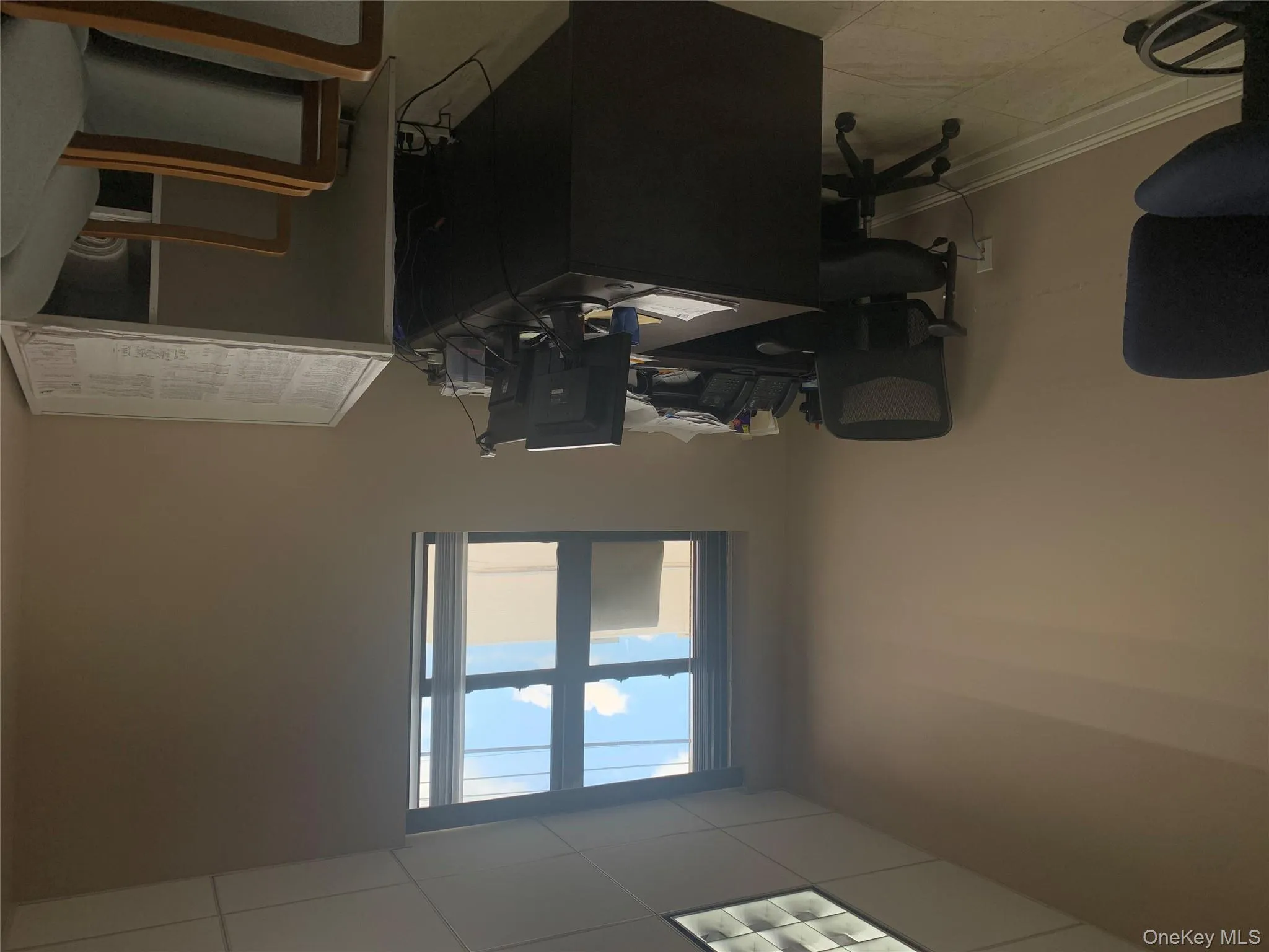 Home office with a drop ceiling and light tile patterned flooring Home office with a drop ceiling and light tile patterned flooring