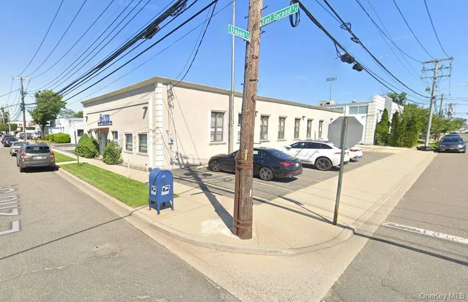 View of building exterior with uncovered parking View of building exterior with uncovered parking