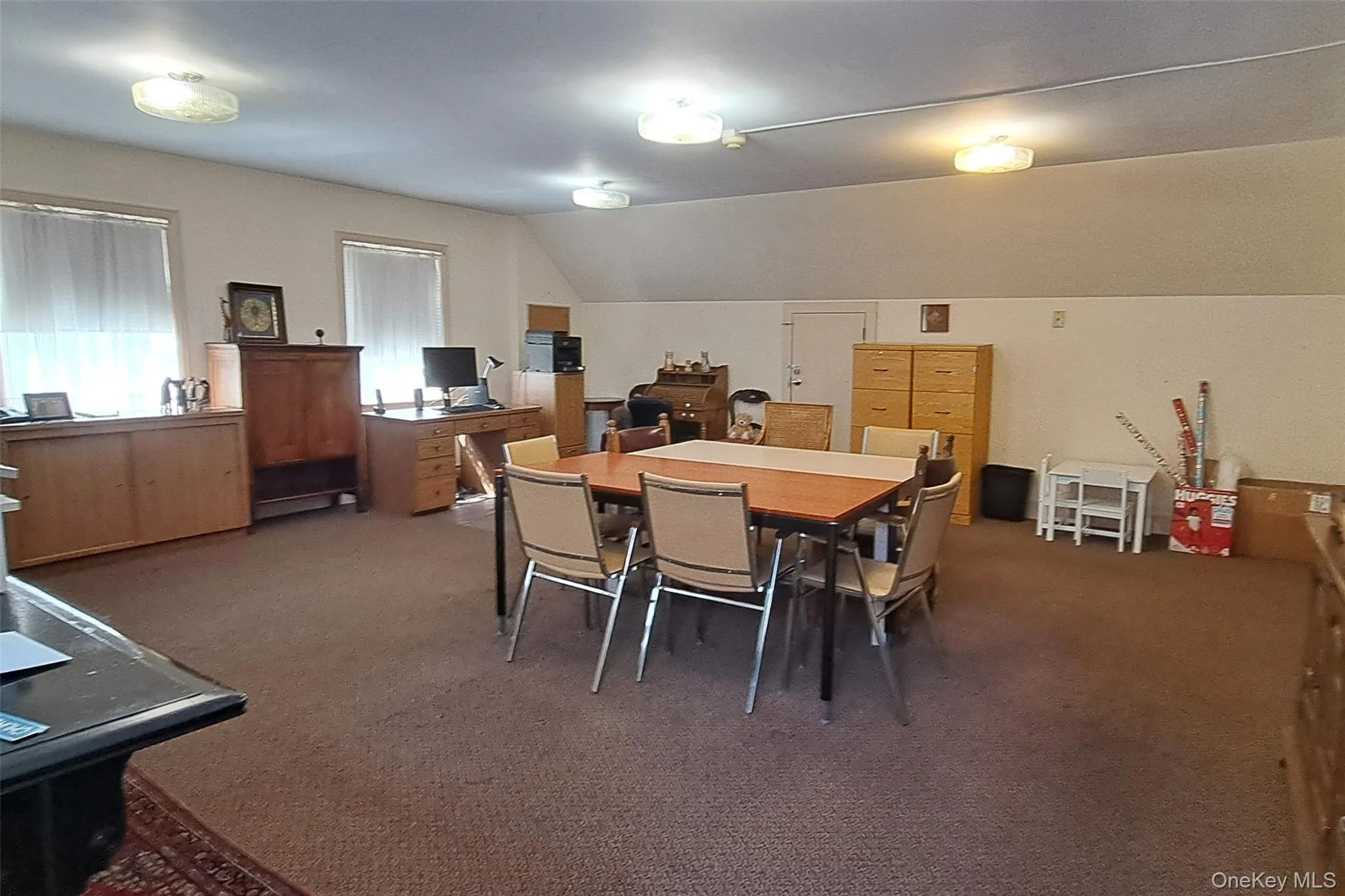 Dining area featuring carpet and lofted ceiling Dining area featuring carpet and lofted ceiling