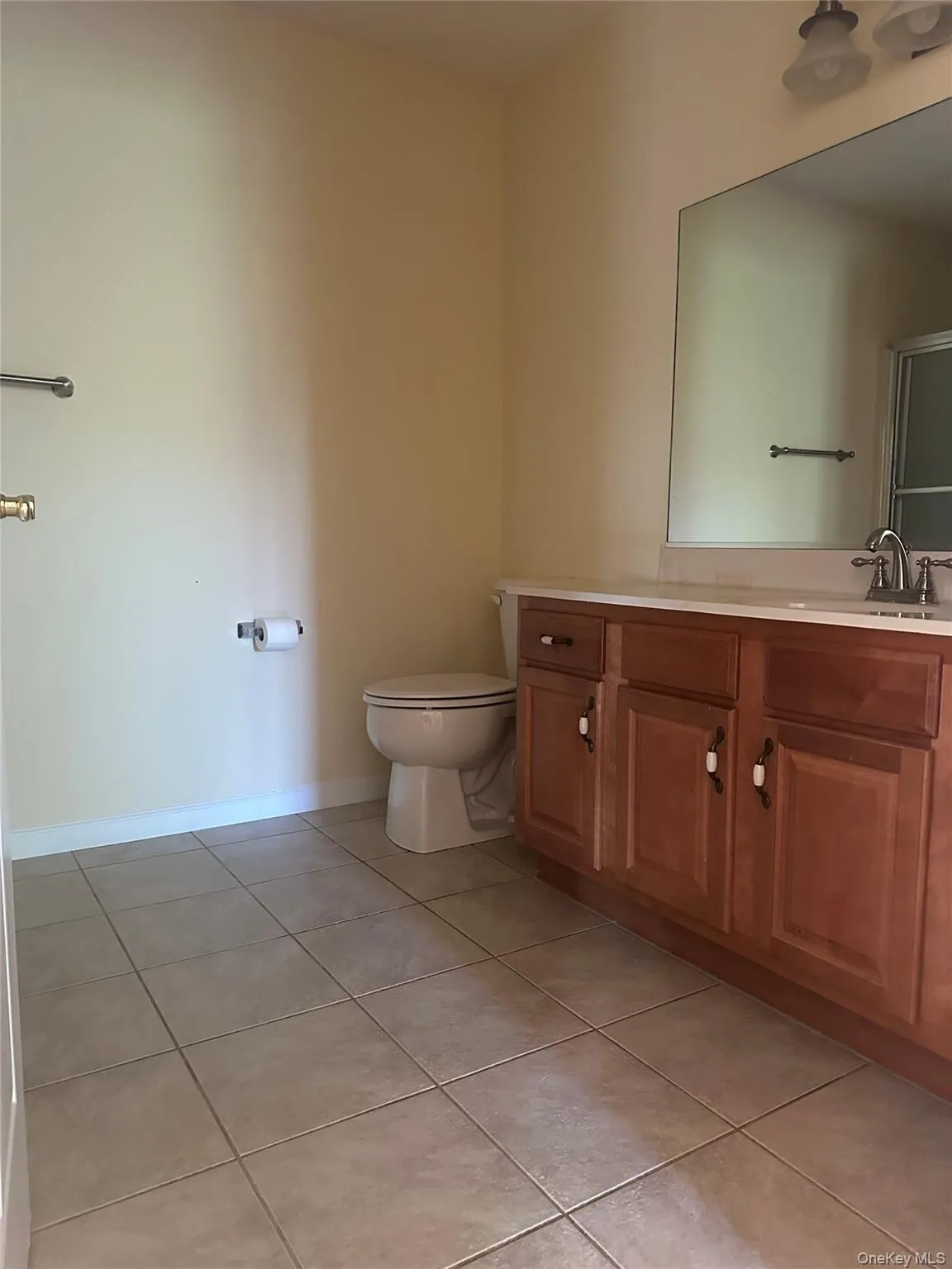 Bathroom featuring vanity and light tile patterned flooring Bathroom featuring vanity and light tile patterned flooring