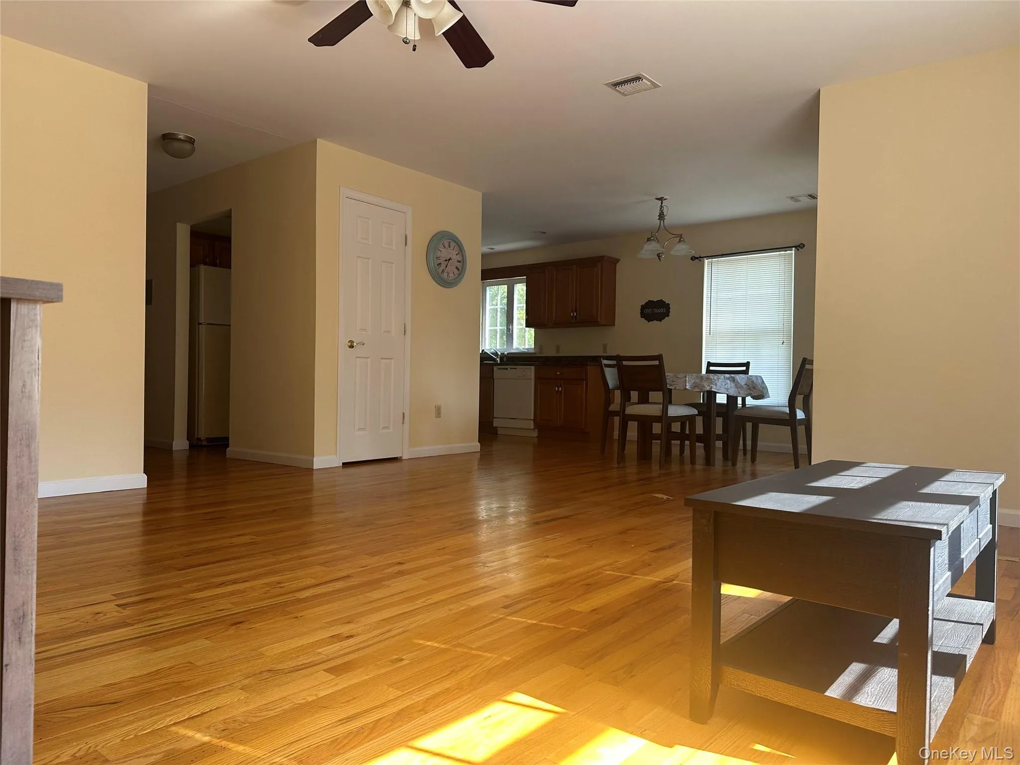 Living room featuring light wood-style floors and ceiling fan Living room featuring light wood-style floors and ceiling fan