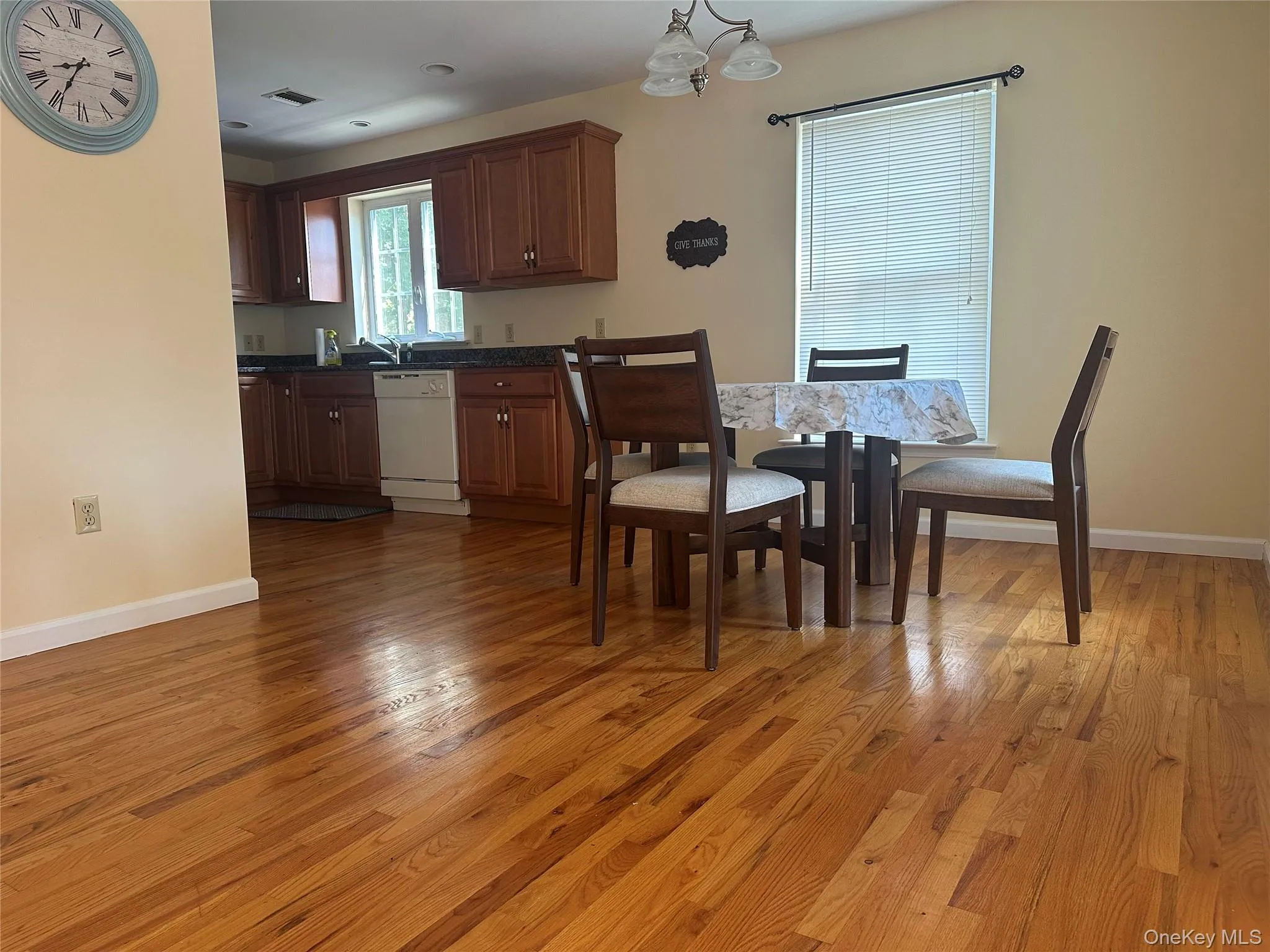 Dining room featuring light wood-style floors and a chandelier Dining room featuring light wood-style floors and a chandelier