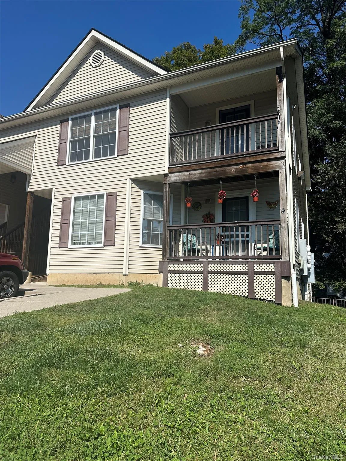 View of front facade featuring a front lawn and covered porch View of front facade featuring a front lawn and covered porch