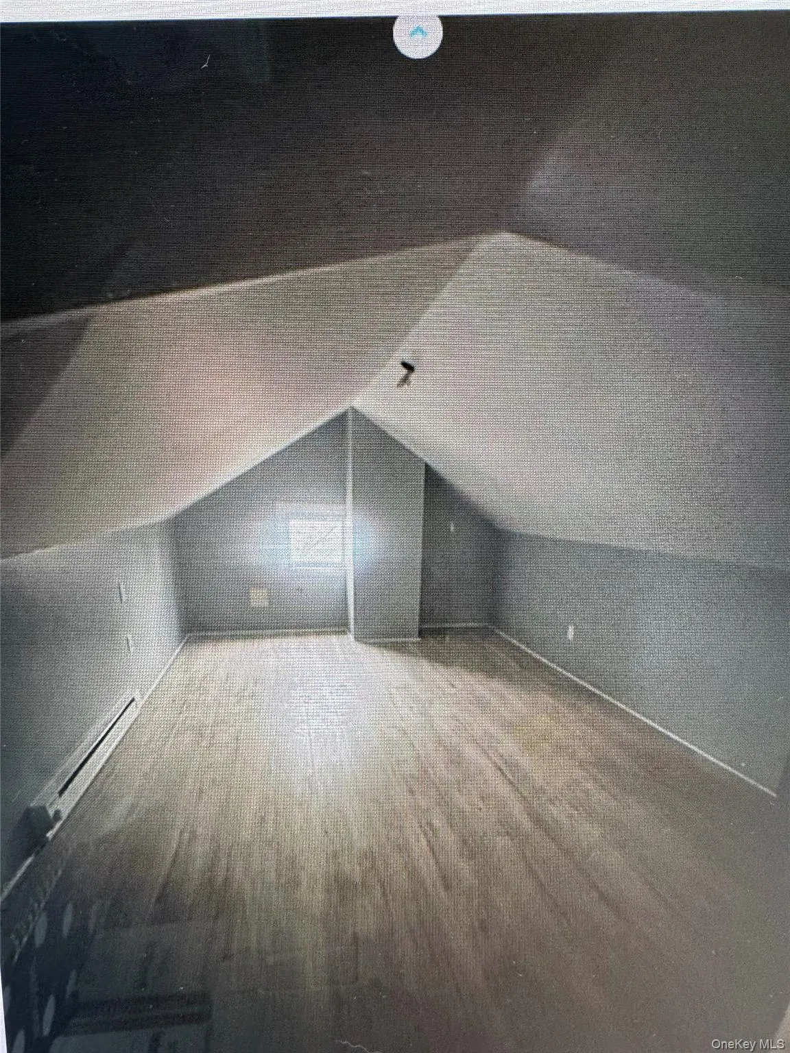 Additional living space with a baseboard radiator, wood finished floors, and vaulted ceiling Additional living space with a baseboard radiator, wood finished floors, and vaulted ceiling