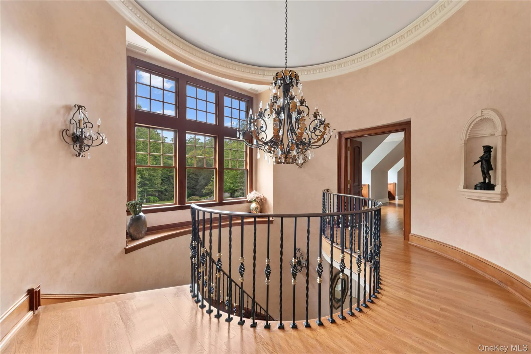 Stairs with wood finished floors, a chandelier, and ornamental molding Stairs with wood finished floors, a chandelier, and ornamental molding