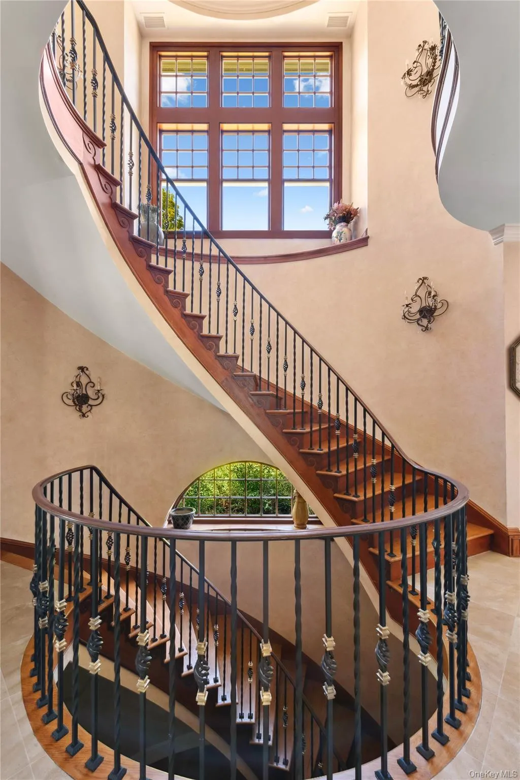 Stairs featuring tile patterned flooring and a high ceiling Stairs featuring tile patterned flooring and a high ceiling