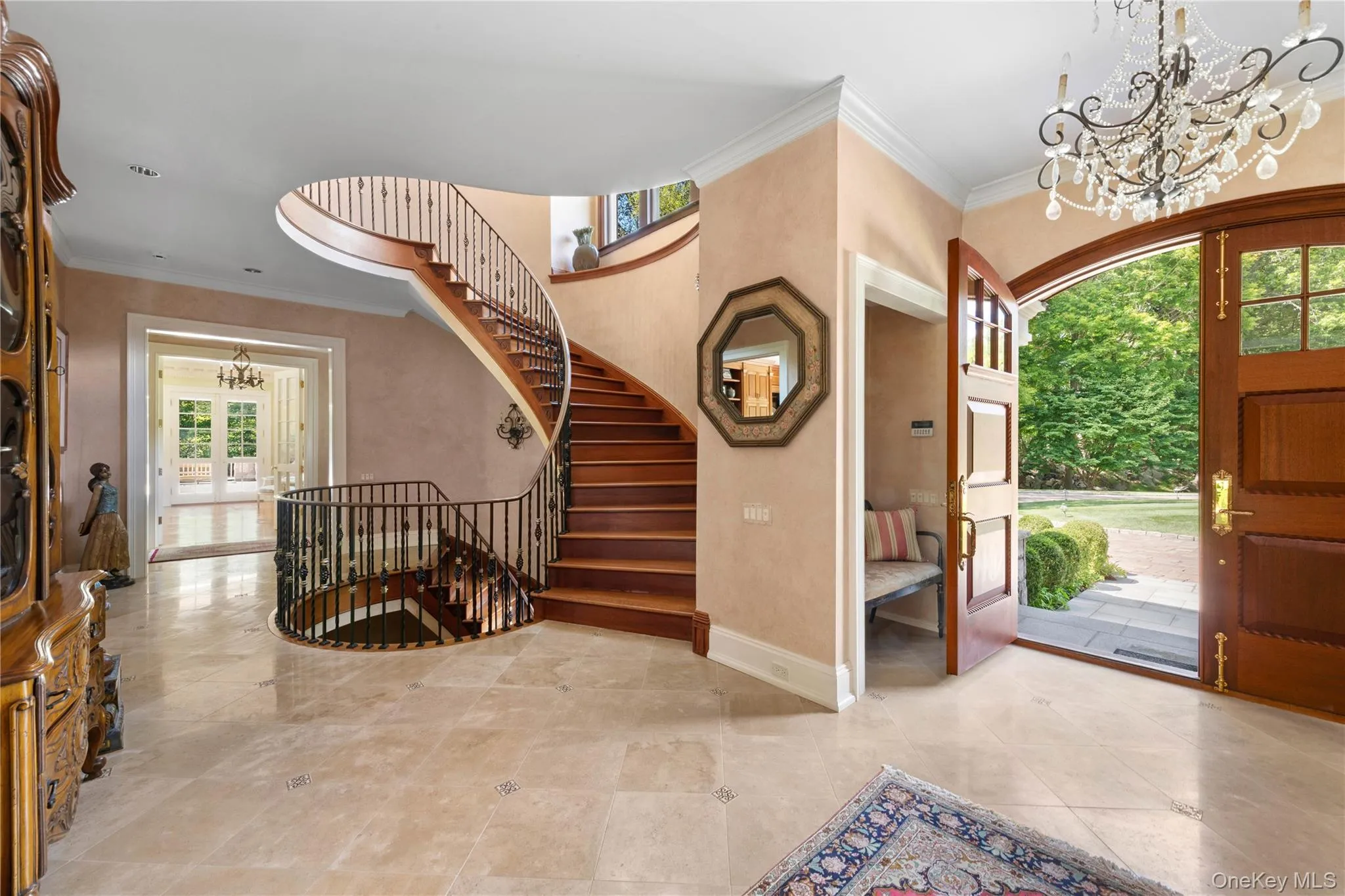 Entryway featuring a chandelier, ornamental molding, french doors, and stairway Entryway featuring a chandelier, ornamental molding, french doors, and stairway