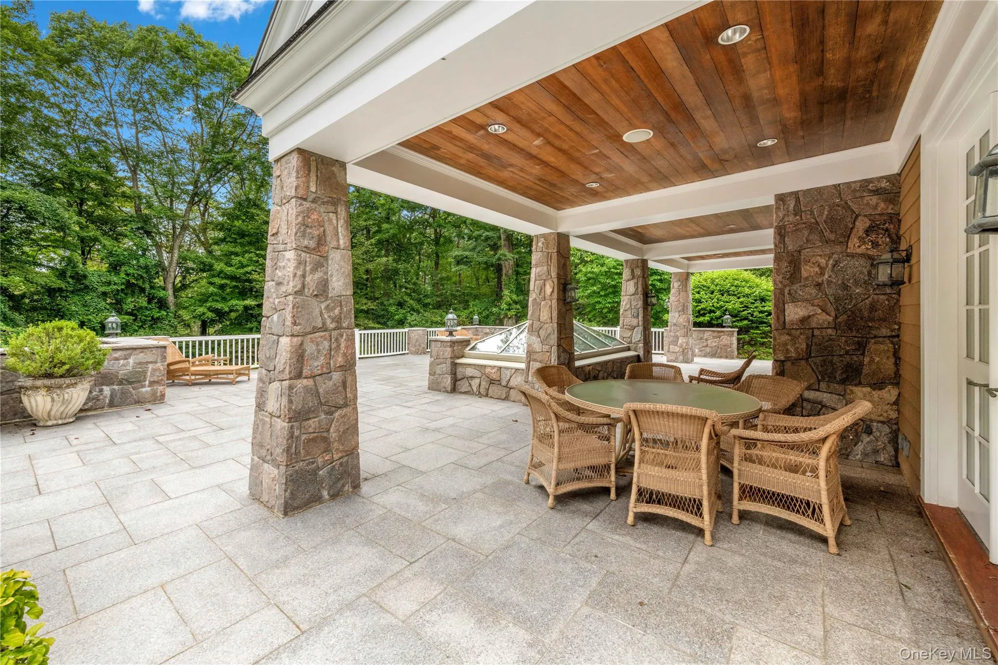 View of patio with outdoor dining area and view of scattered trees View of patio with outdoor dining area and view of scattered trees