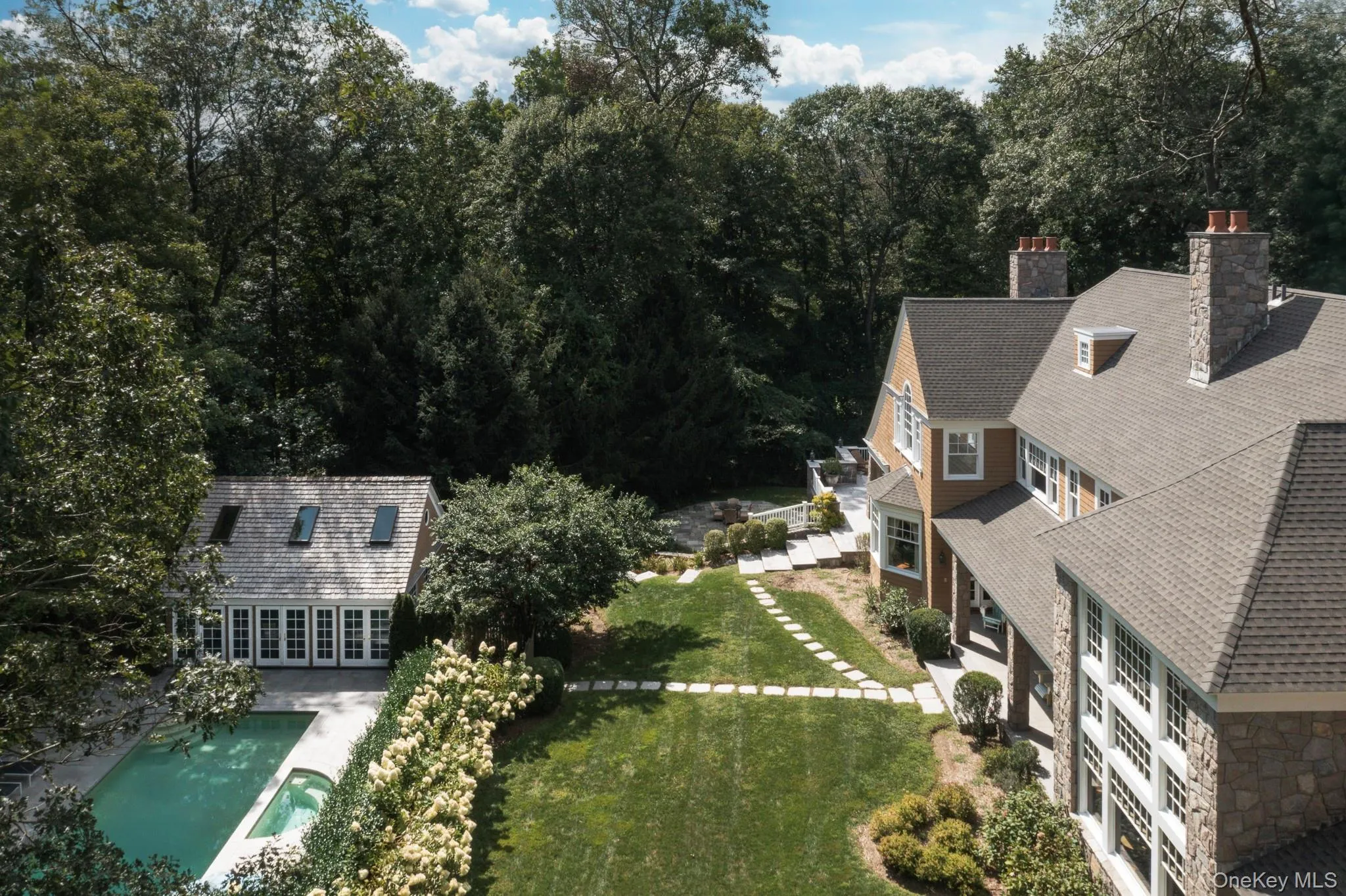 Aerial view of property and surrounding area featuring a pool Aerial view of property and surrounding area featuring a pool
