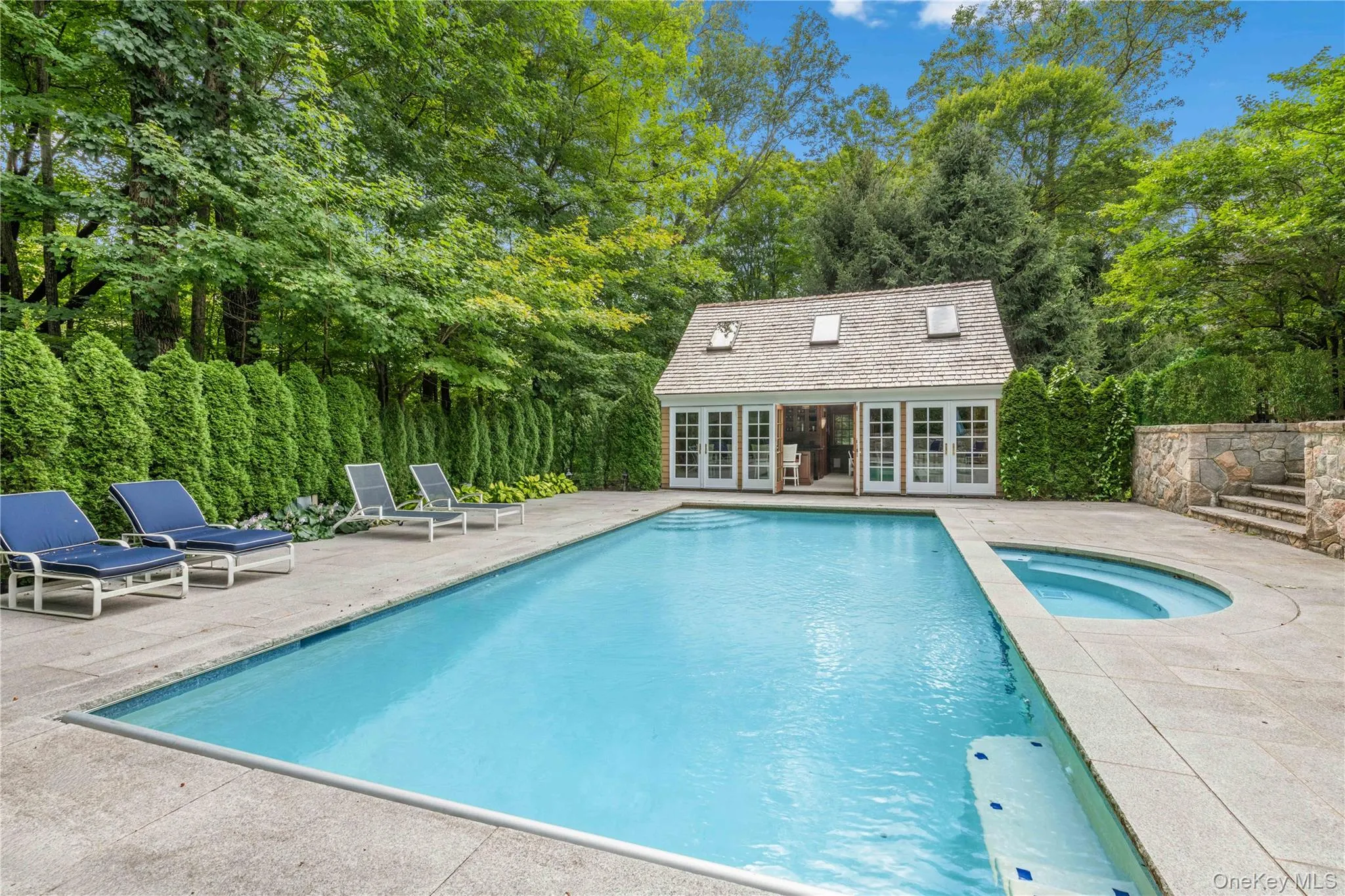 View of pool with an exterior structure, an outdoor structure, a patio, and a pool with connected hot tub View of pool with an exterior structure, an outdoor structure, a patio, and a pool with connected hot tub