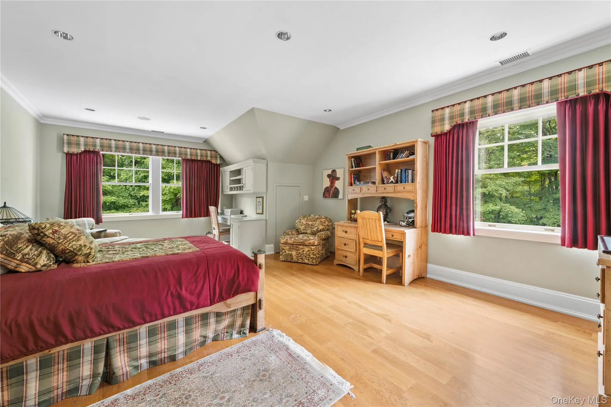 Bedroom with crown molding, light wood-style floors, and vaulted ceiling Bedroom with crown molding, light wood-style floors, and vaulted ceiling