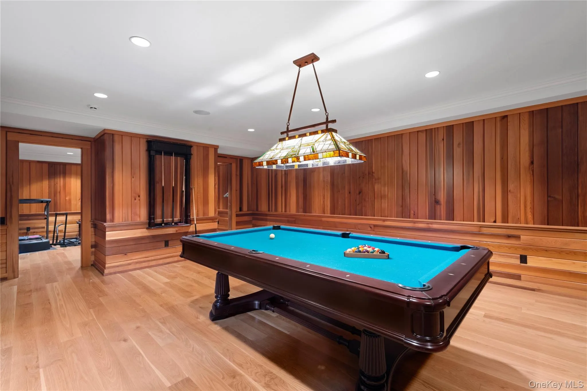 Rec room featuring billiards, wooden walls, crown molding, light wood-type flooring, and recessed lighting Rec room featuring billiards, wooden walls, crown molding, light wood-type flooring, and recessed lighting