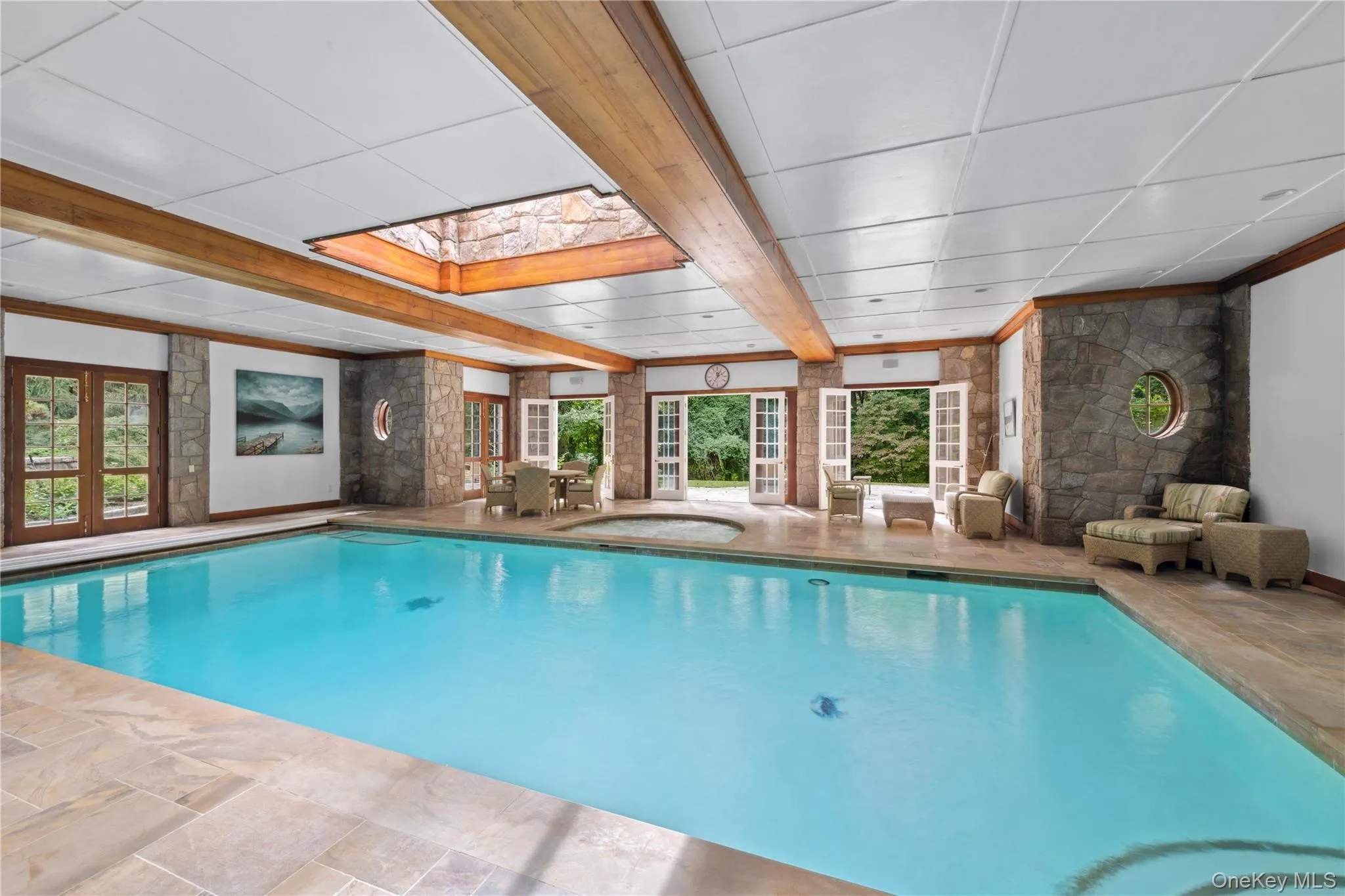 Indoor pool featuring a skylight Indoor pool featuring a skylight