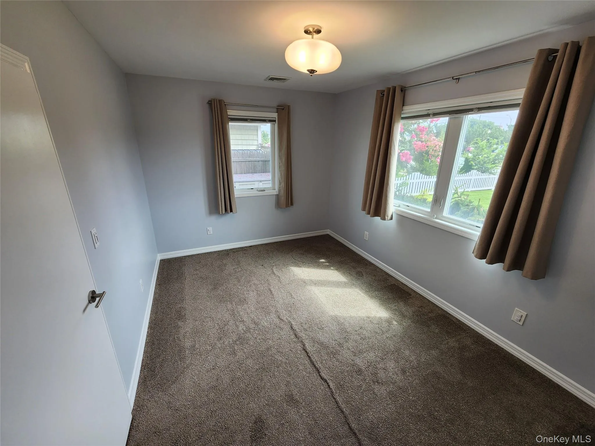 Spare room featuring carpet and baseboards Spare room featuring carpet and baseboards