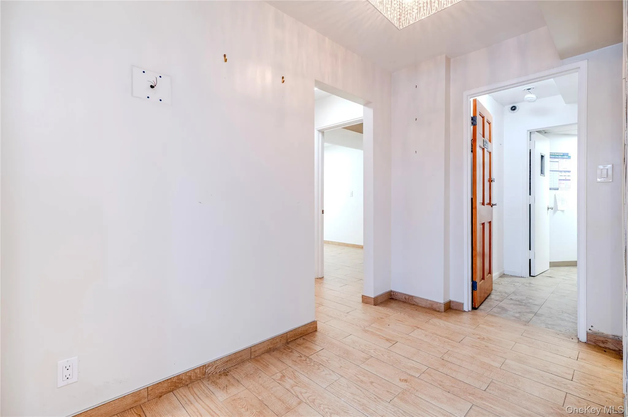 Empty room featuring baseboards and light wood finished floors Empty room featuring baseboards and light wood finished floors