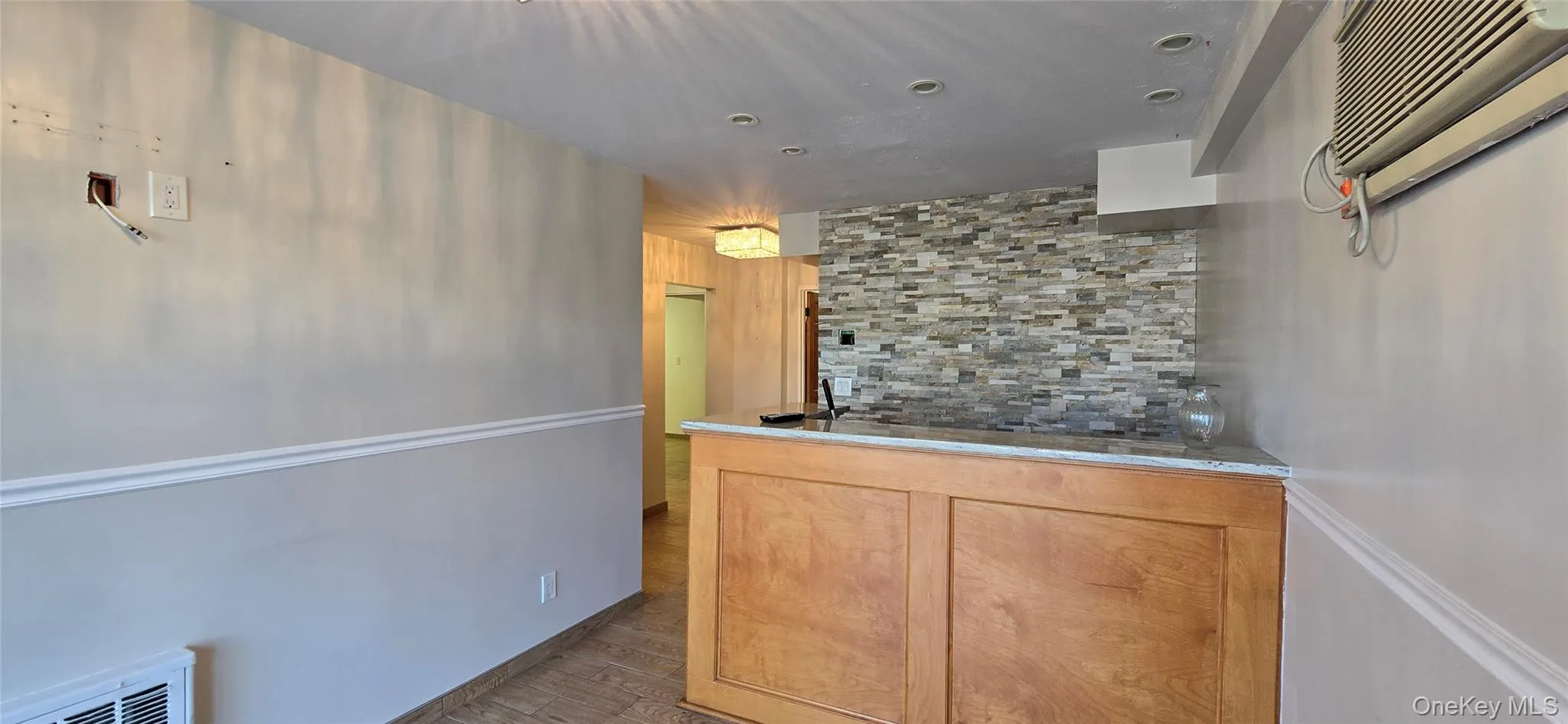 Kitchen featuring dark wood-type flooring and tasteful backsplash Kitchen featuring dark wood-type flooring and tasteful backsplash