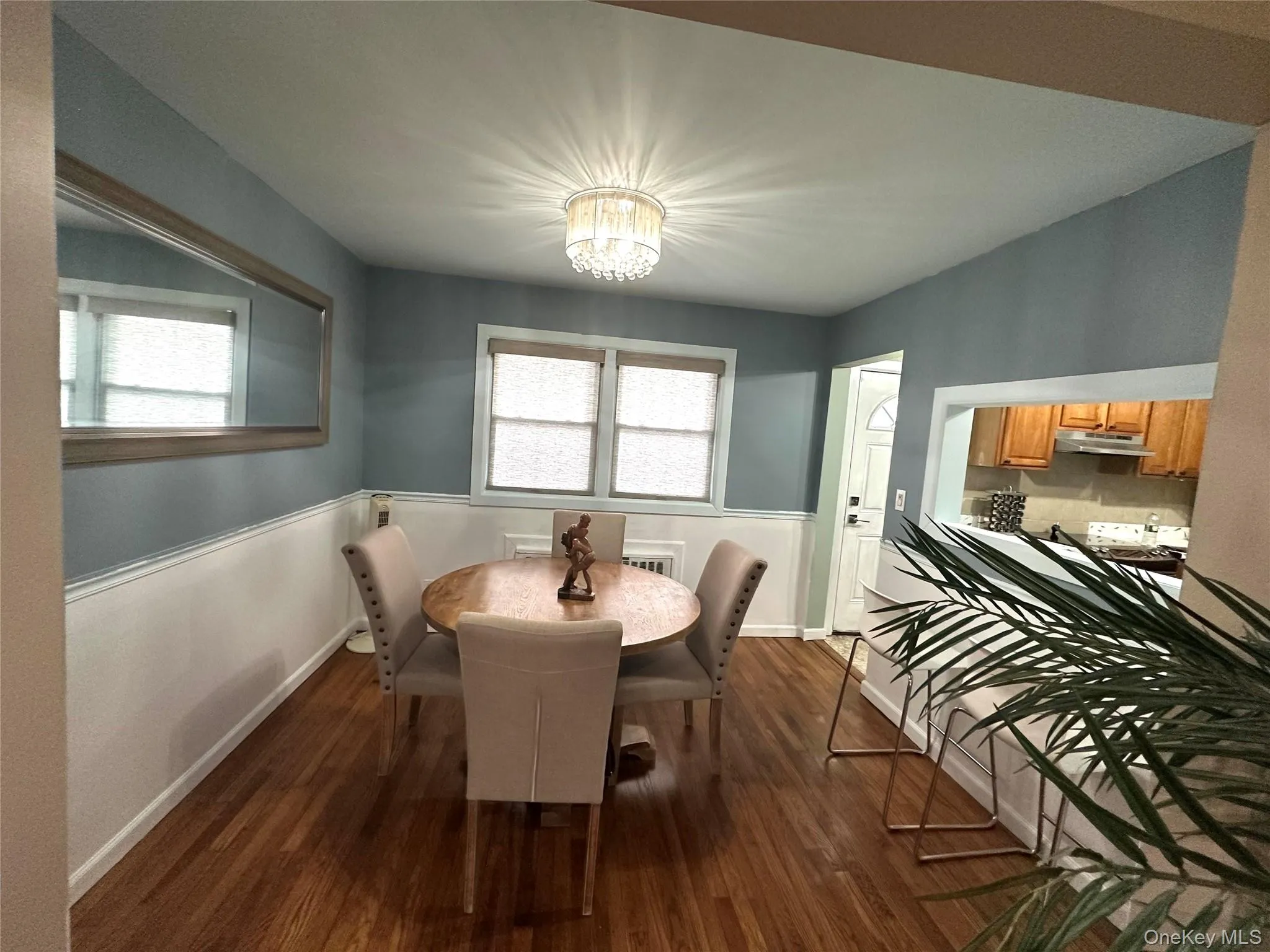 Dining room with dark wood finished floors and a chandelier Dining room with dark wood finished floors and a chandelier