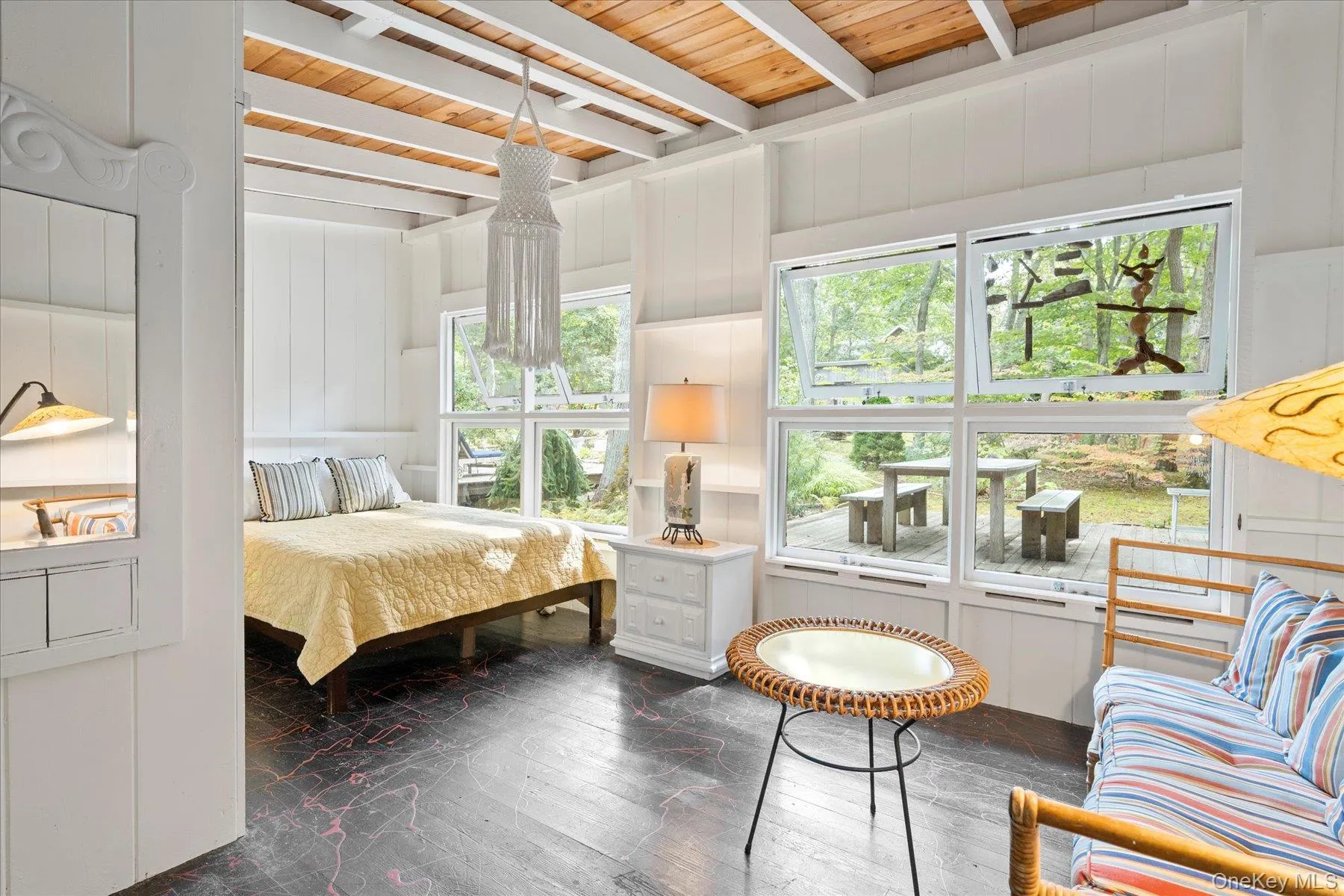 Bedroom featuring dark wood-style floors and a wooden ceiling with exposed beams