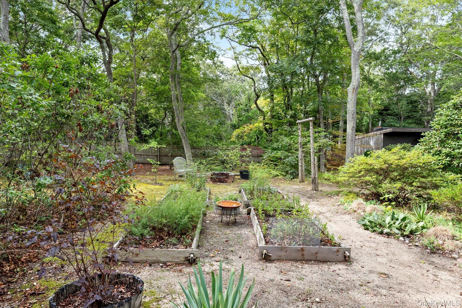 Fenced yard featuring a vegetable garden