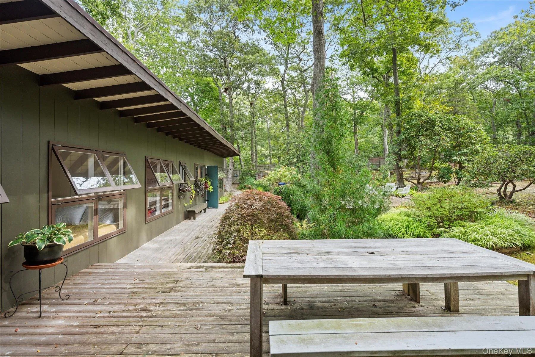 Wooden deck featuring view of wooded area