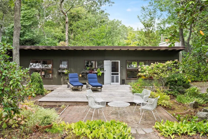 Back of property featuring a patio area and a wooden deck