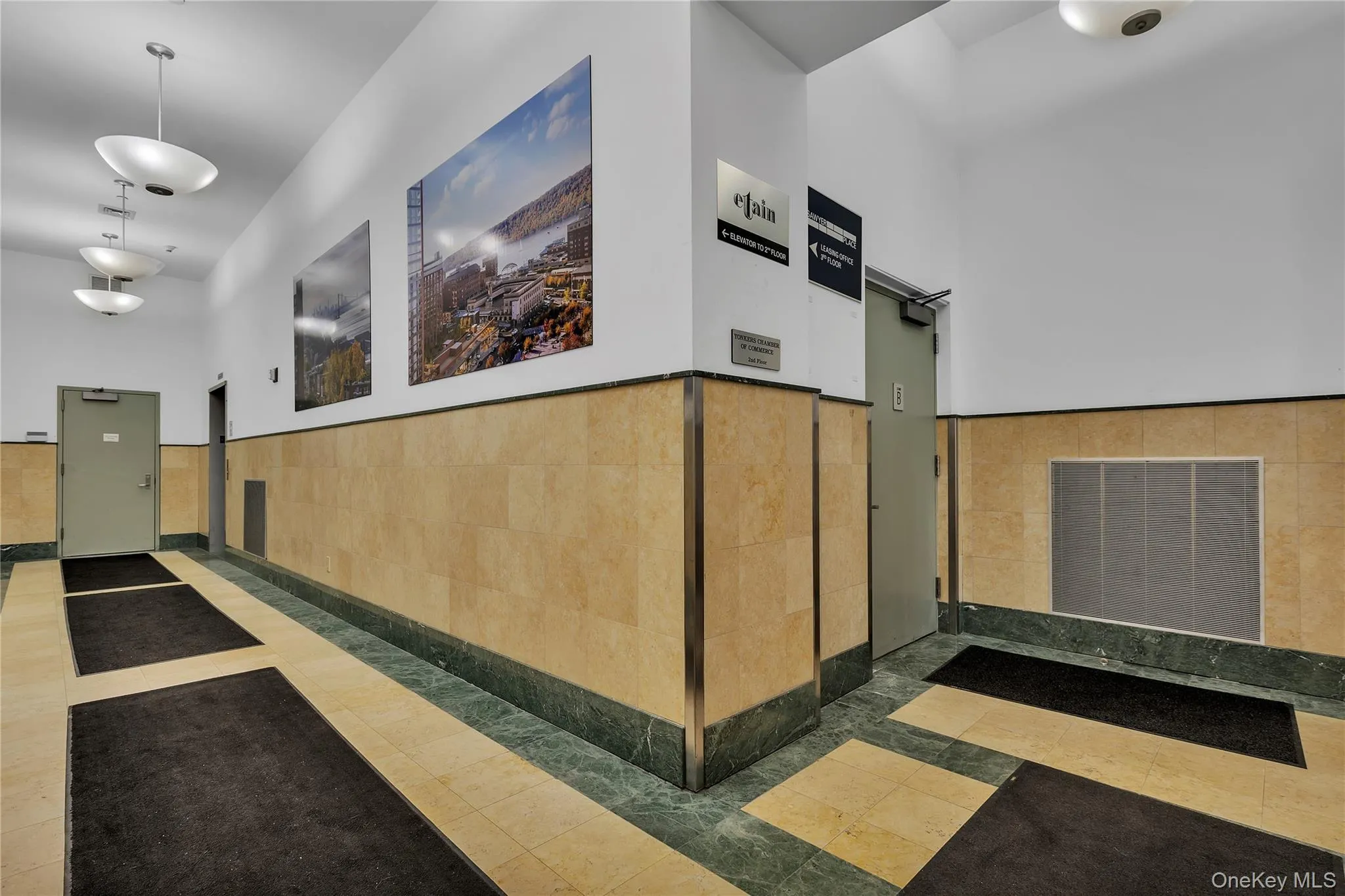 Reception area featuring tile walls and a wainscoted wall Reception area featuring tile walls and a wainscoted wall