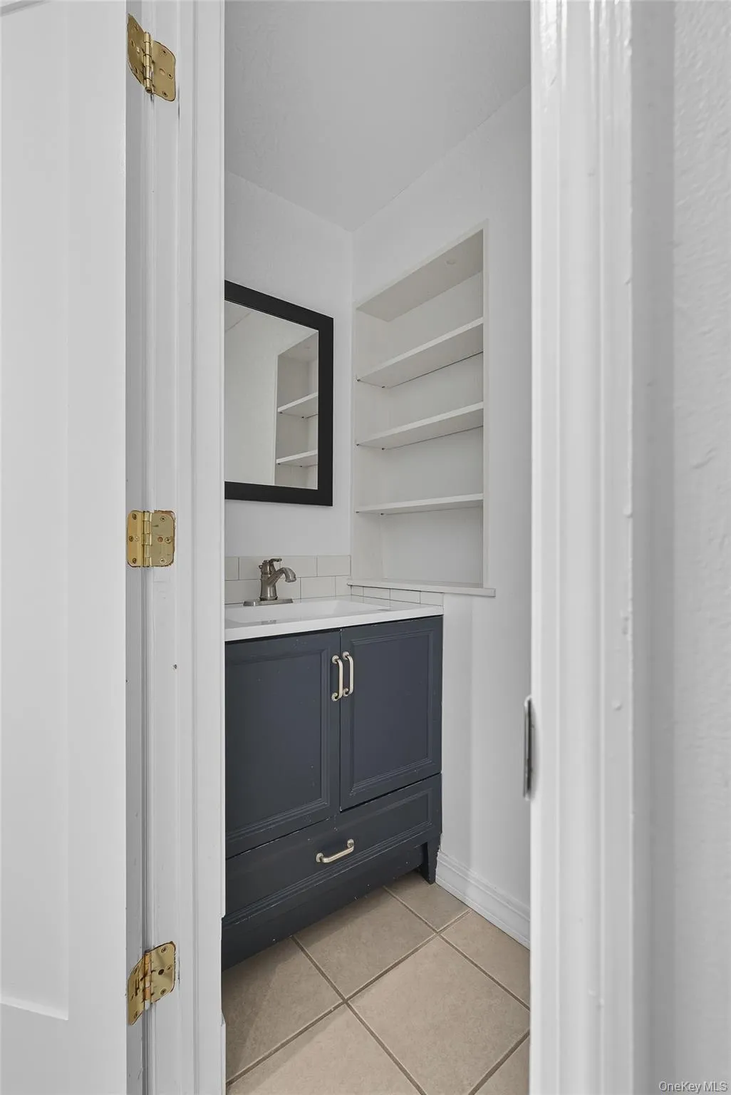 Bathroom with light tile patterned floors and vanity Bathroom with light tile patterned floors and vanity