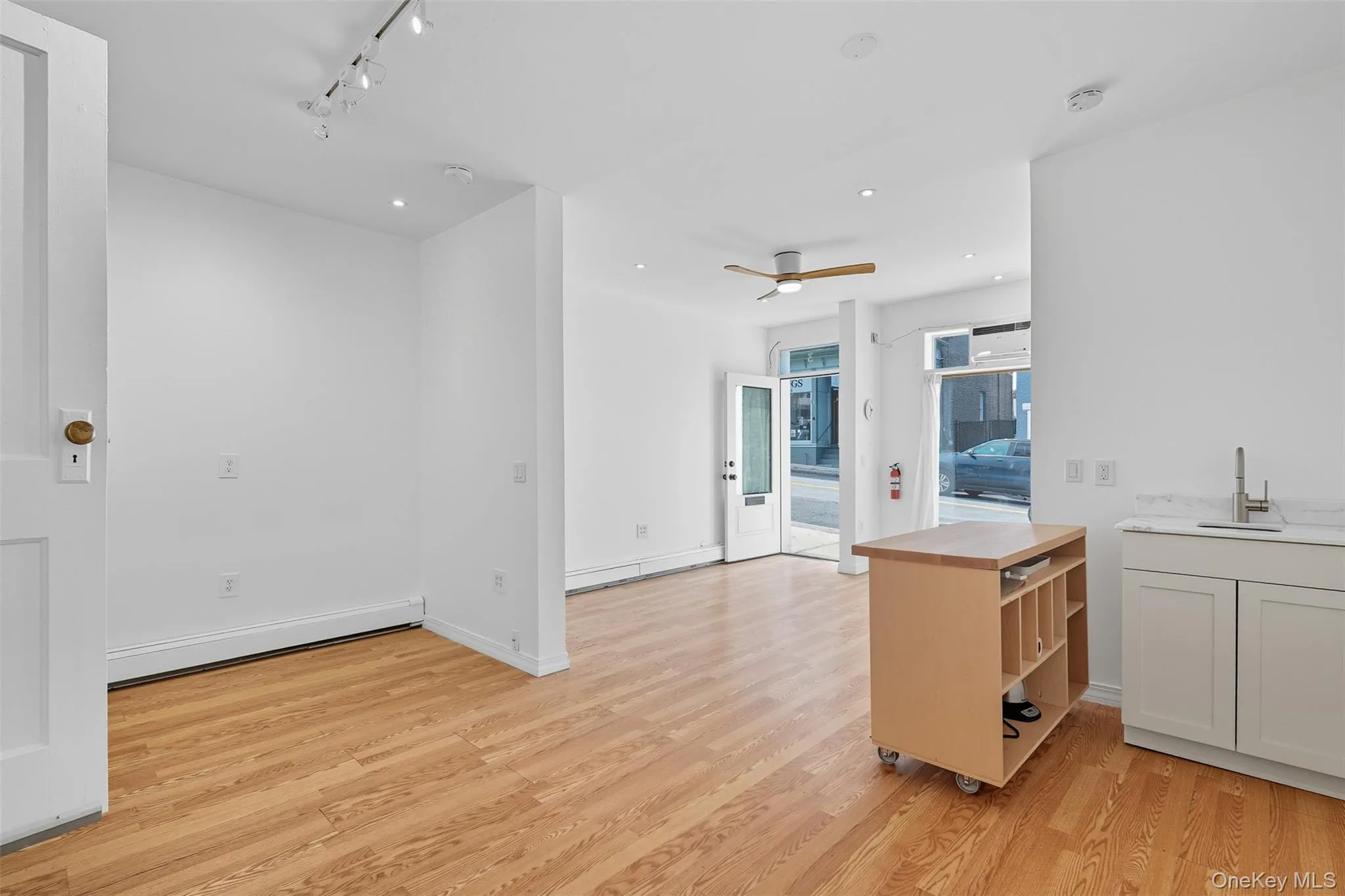 Kitchen with light wood-type flooring, ceiling fan, recessed lighting, and butcher block counters Kitchen with light wood-type flooring, ceiling fan, recessed lighting, and butcher block counters