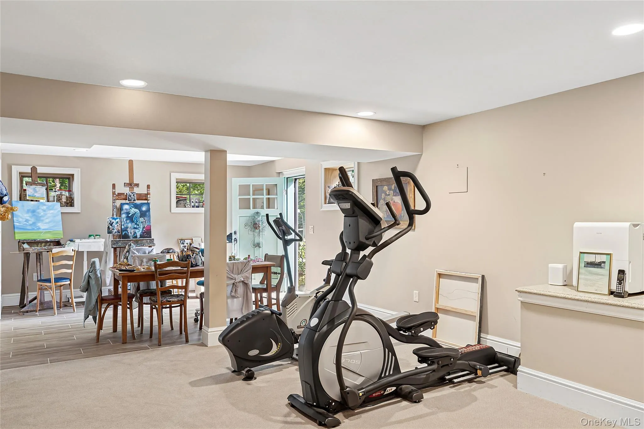 Exercise room with recessed lighting and light carpet Exercise room with recessed lighting and light carpet