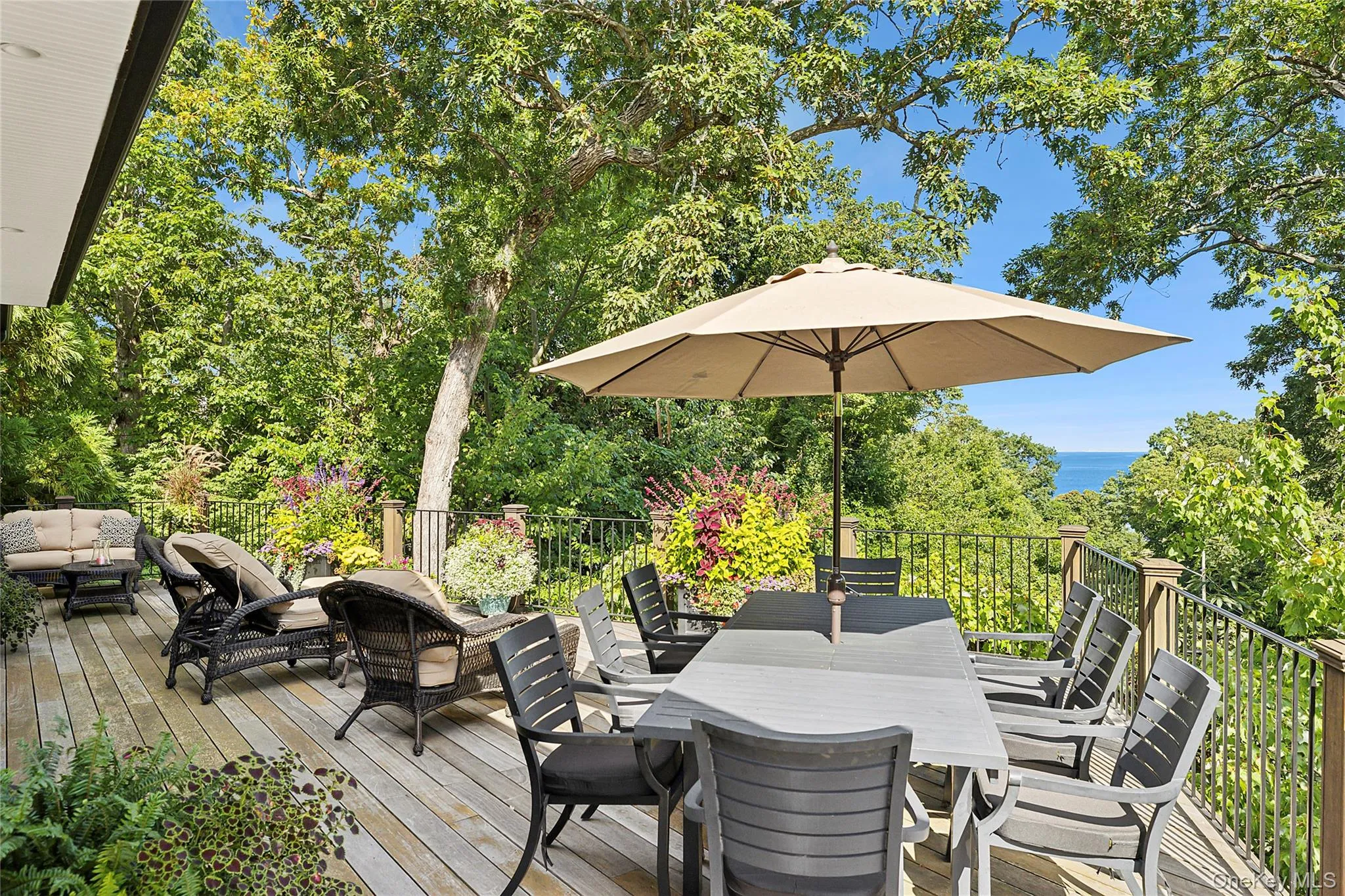 Wooden deck featuring outdoor dining space and an outdoor hangout area Wooden deck featuring outdoor dining space and an outdoor hangout area