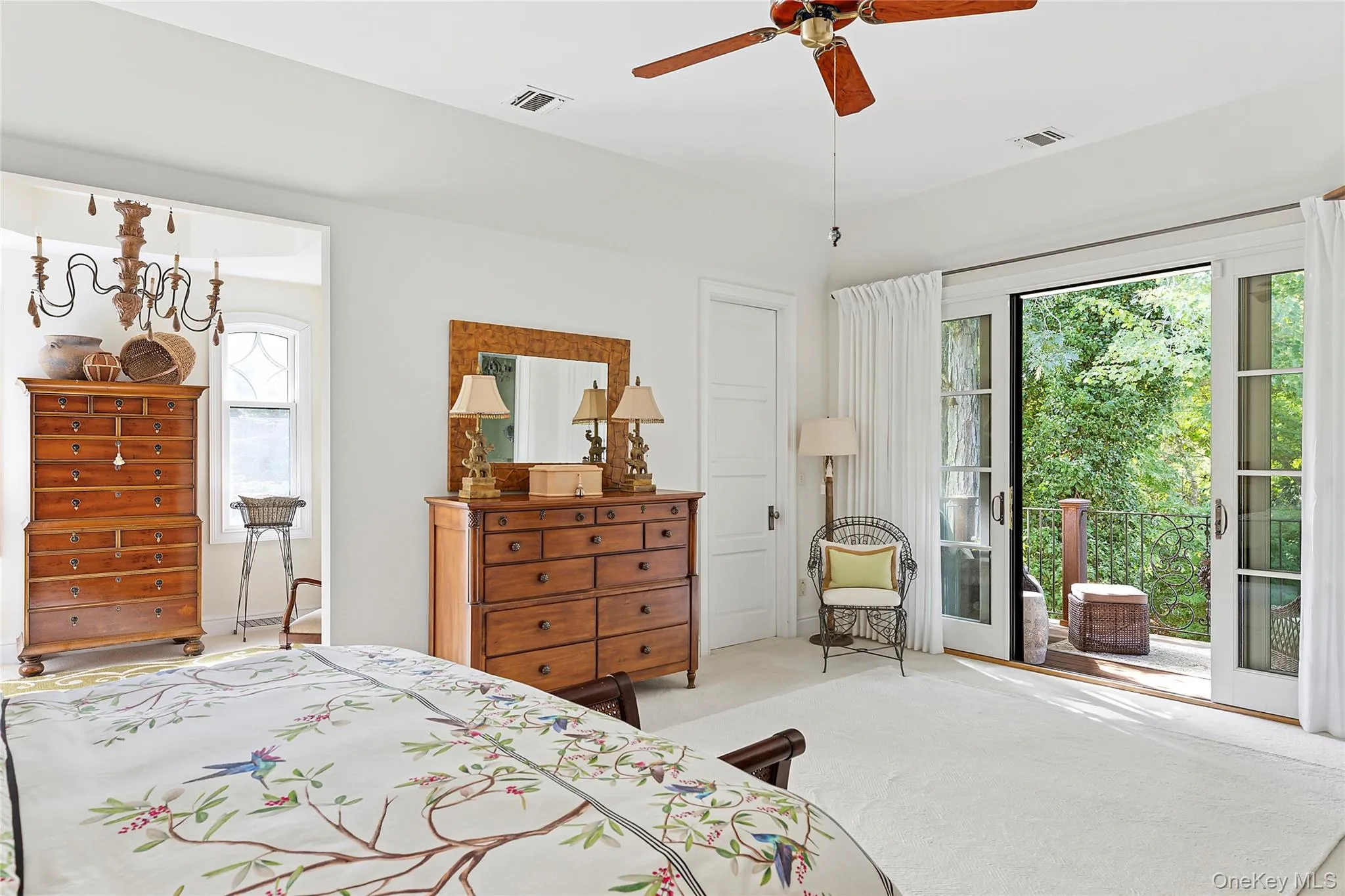 Carpeted bedroom with a ceiling fan and access to outside Carpeted bedroom with a ceiling fan and access to outside