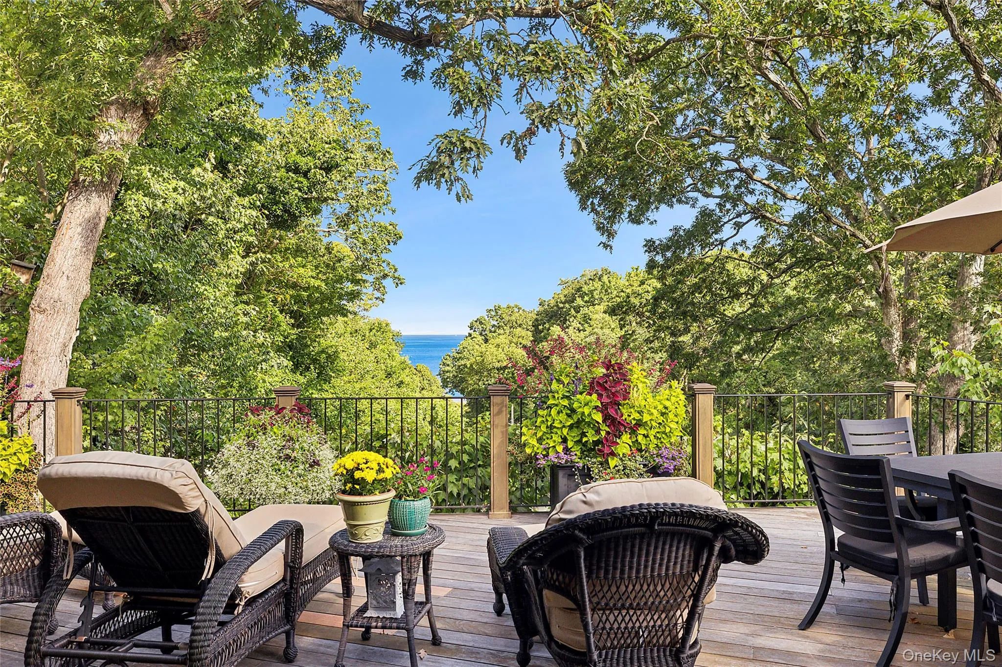 Wooden terrace with a water view and outdoor dining area Wooden terrace with a water view and outdoor dining area
