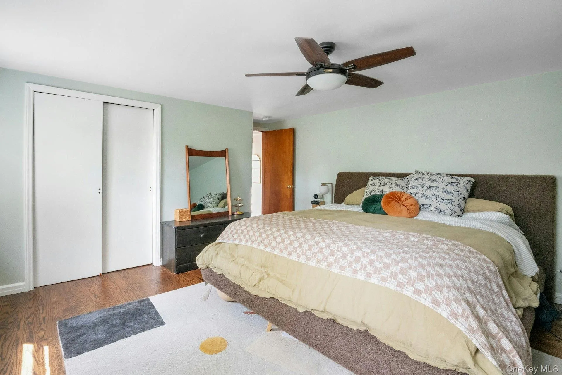 Bedroom with wood finished floors, a ceiling fan, and a closet Bedroom with wood finished floors, a ceiling fan, and a closet
