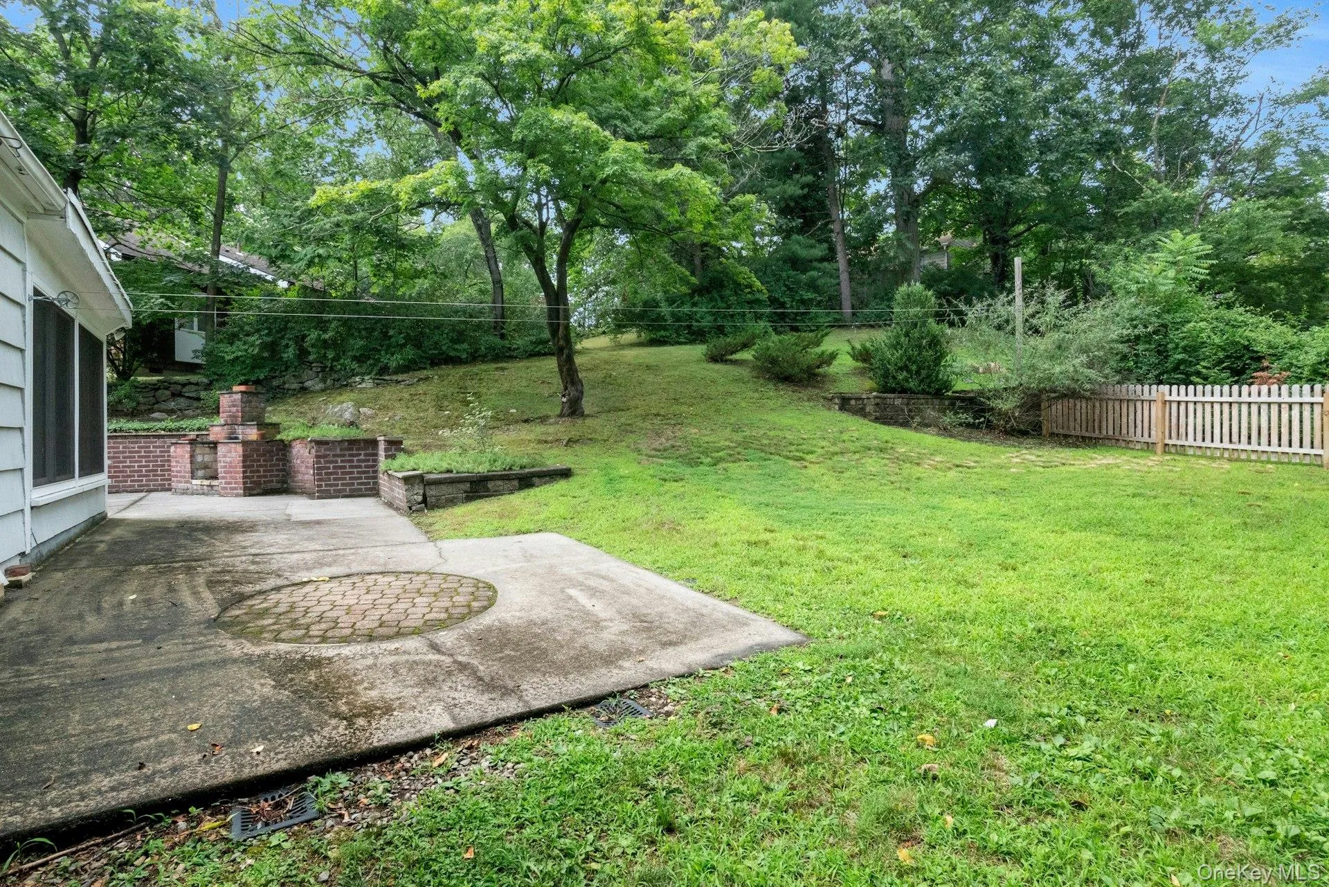 View of yard with a patio area and view of scattered trees View of yard with a patio area and view of scattered trees