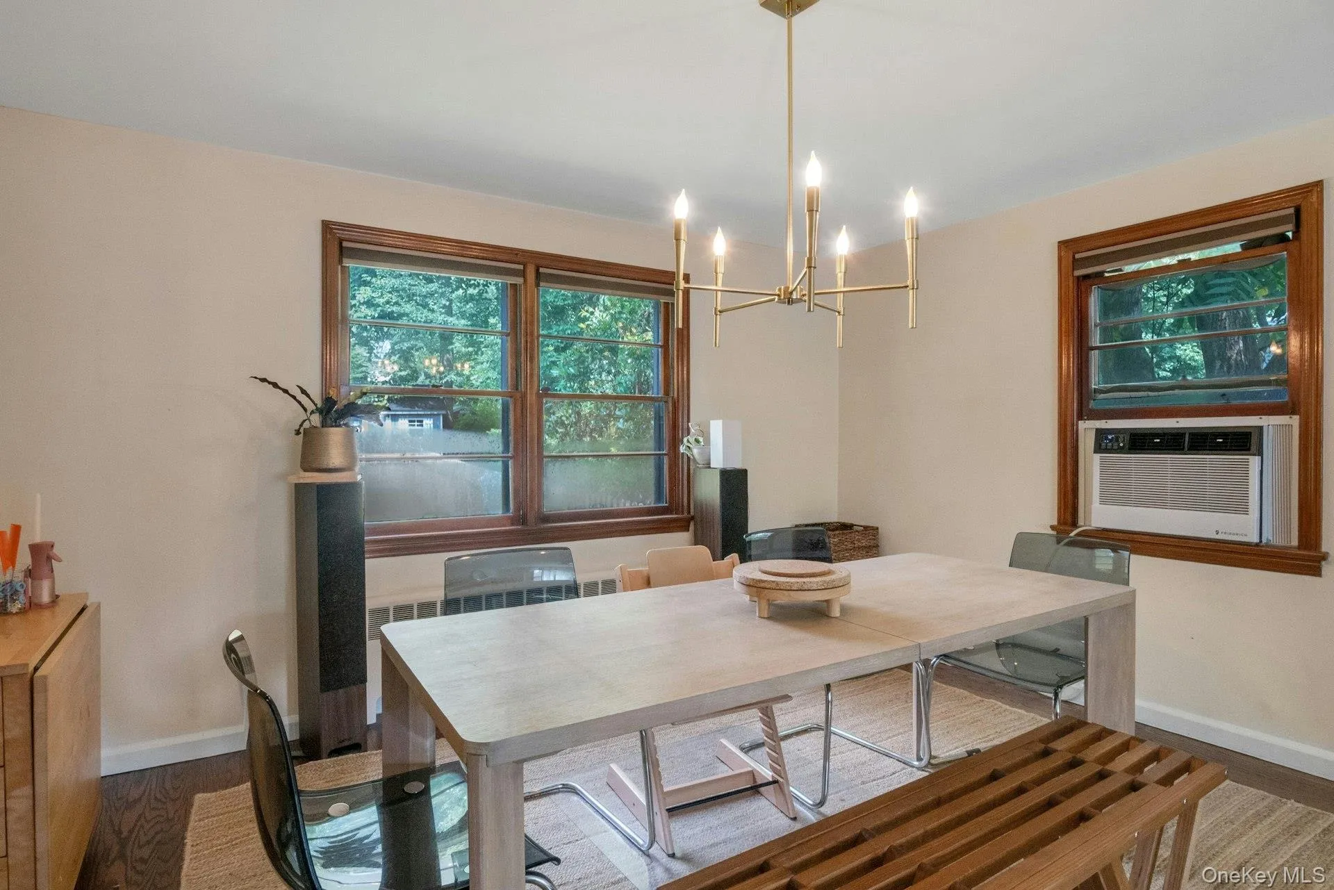 Dining area featuring a chandelier, radiator heating unit, and wood finished floors Dining area featuring a chandelier, radiator heating unit, and wood finished floors