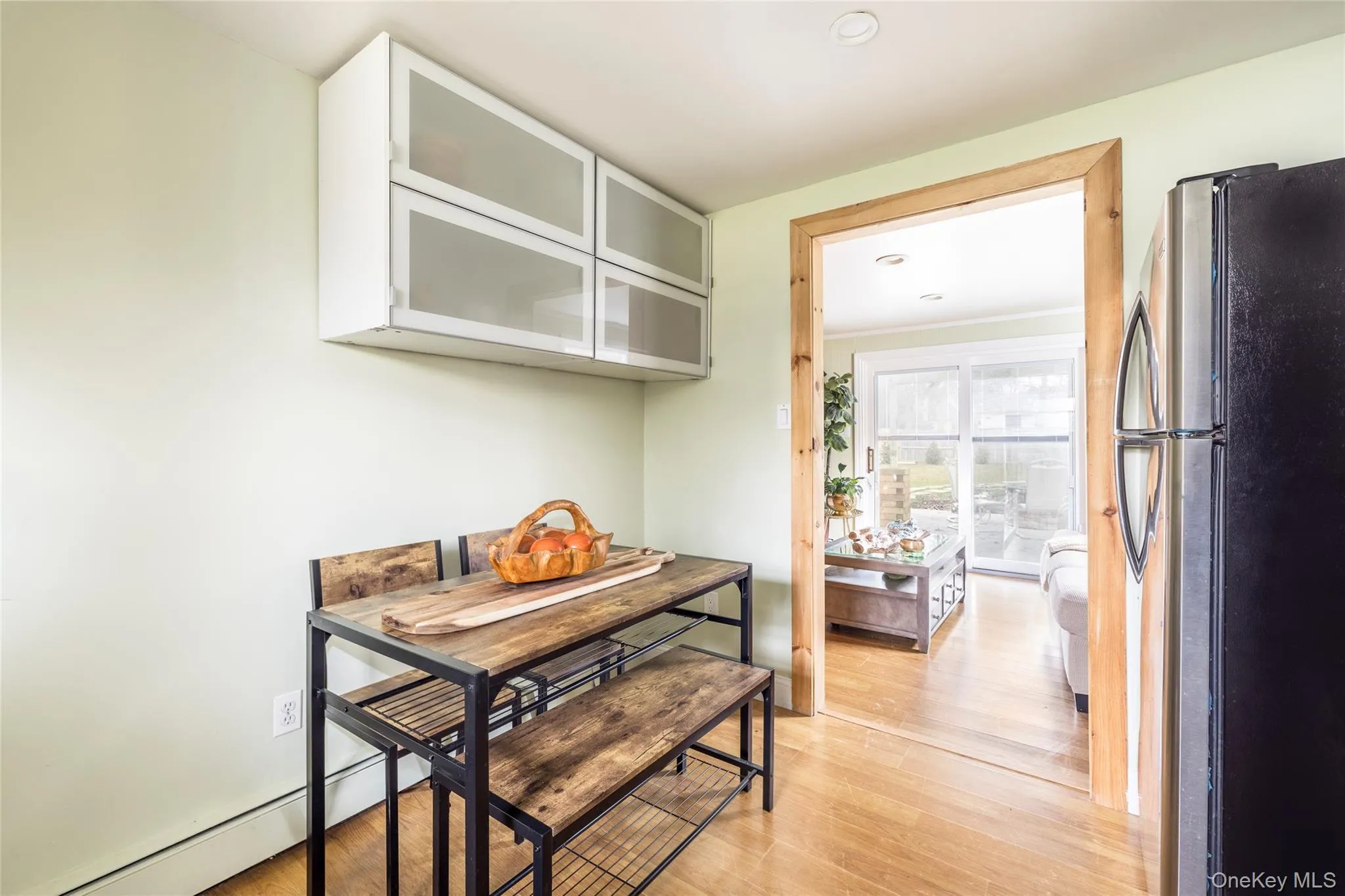 Dining area with light wood finished floors, baseboard heating, and recessed lighting Dining area with light wood finished floors, baseboard heating, and recessed lighting