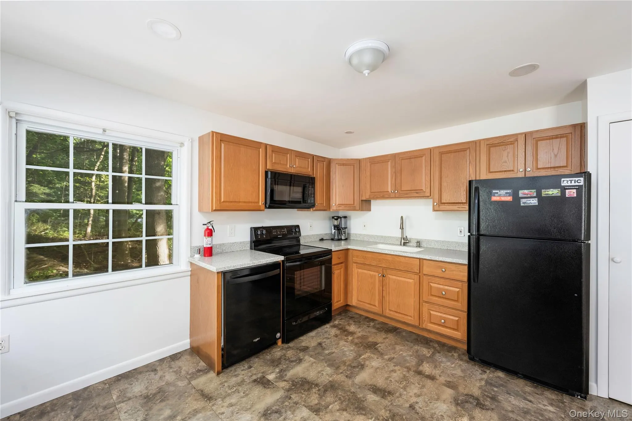 Kitchen with black appliances and brown cabinets Kitchen with black appliances and brown cabinets