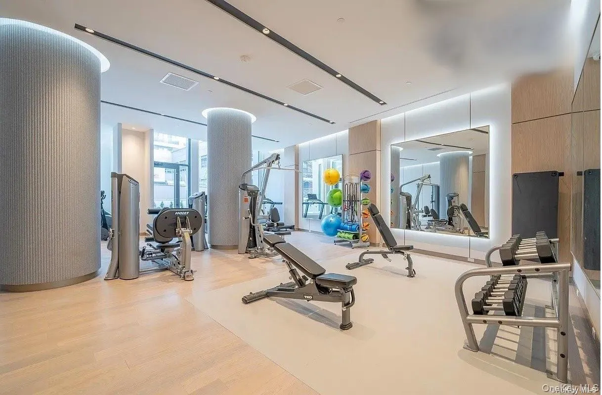 Workout area with wood finished floors Workout area with wood finished floors